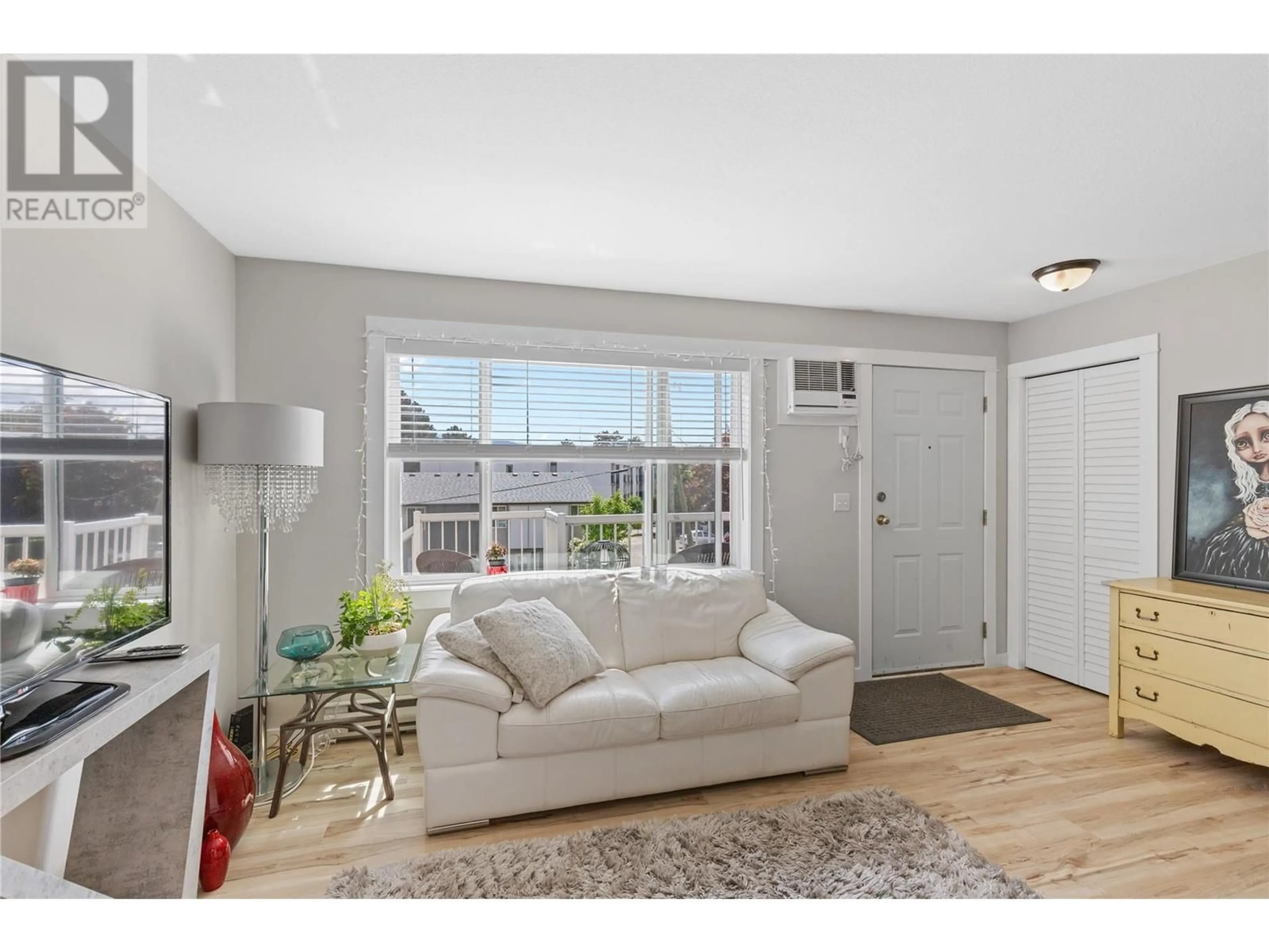 Living room with furniture, wood/laminate floor for 229 - 4202 ALEXIS PARK DRIVE, Vernon British Columbia V1T5L4