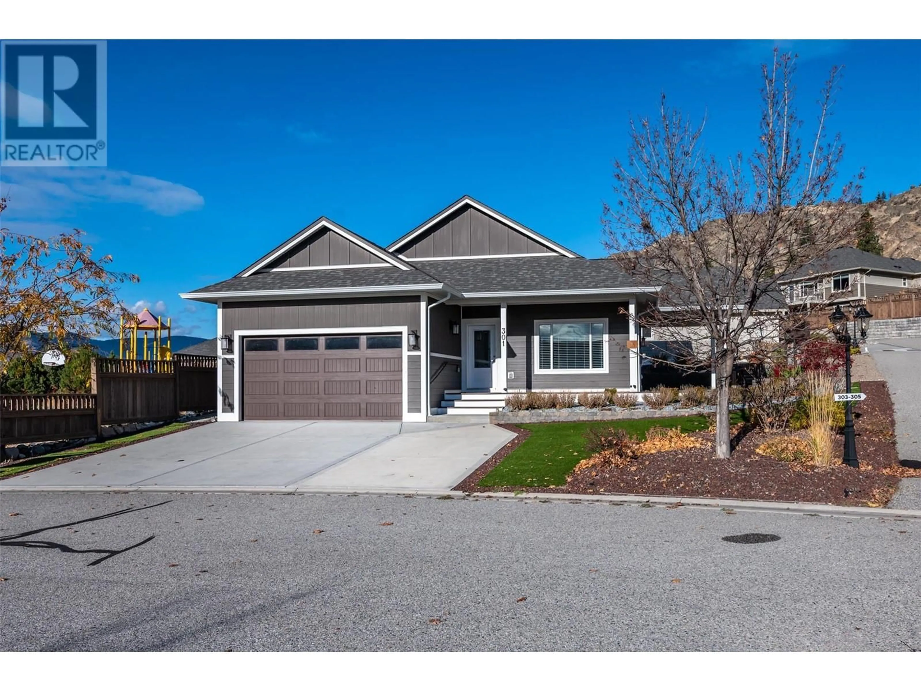 Home with vinyl exterior material, street for 301 - 4400 MCLEAN CREEK ROAD, Okanagan Falls British Columbia V0H1R6