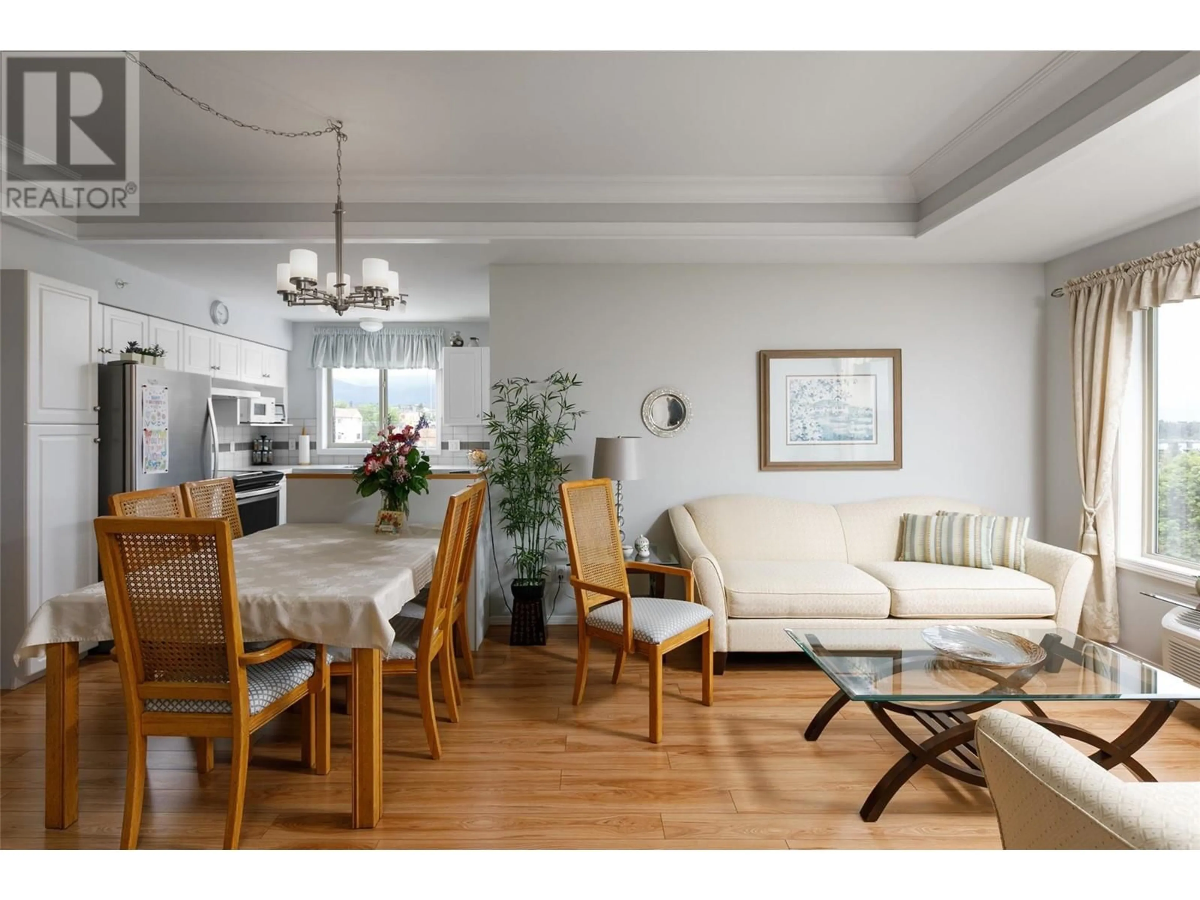 Living room with furniture, wood/laminate floor for 412 - 265 FROELICH ROAD, Kelowna British Columbia V1X3M6