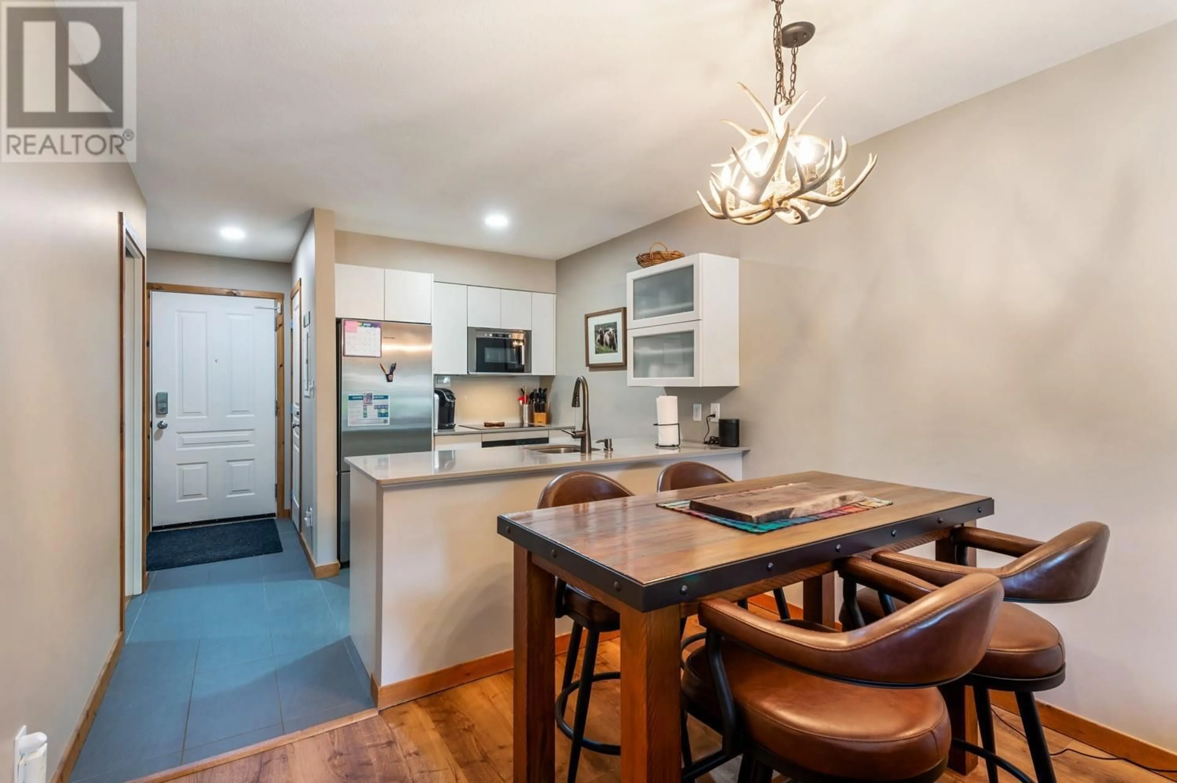 Open concept kitchen, wood/laminate floor for 306 - 9808 SILVER STAR ROAD, Vernon British Columbia V1B3X4