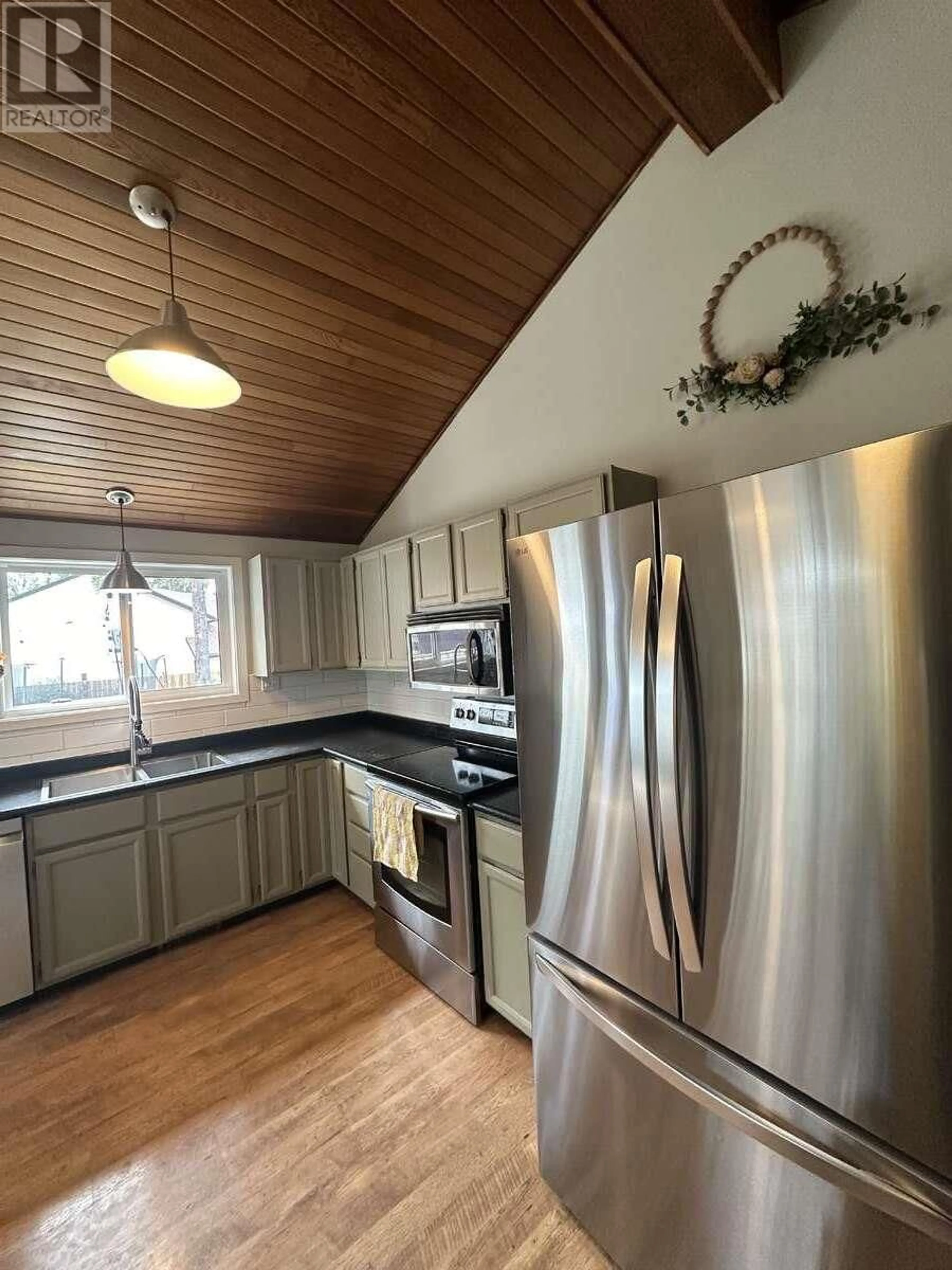 Open concept kitchen, wood/laminate floor for 120 BERGERON DRIVE, Tumbler Ridge British Columbia V0C2W0