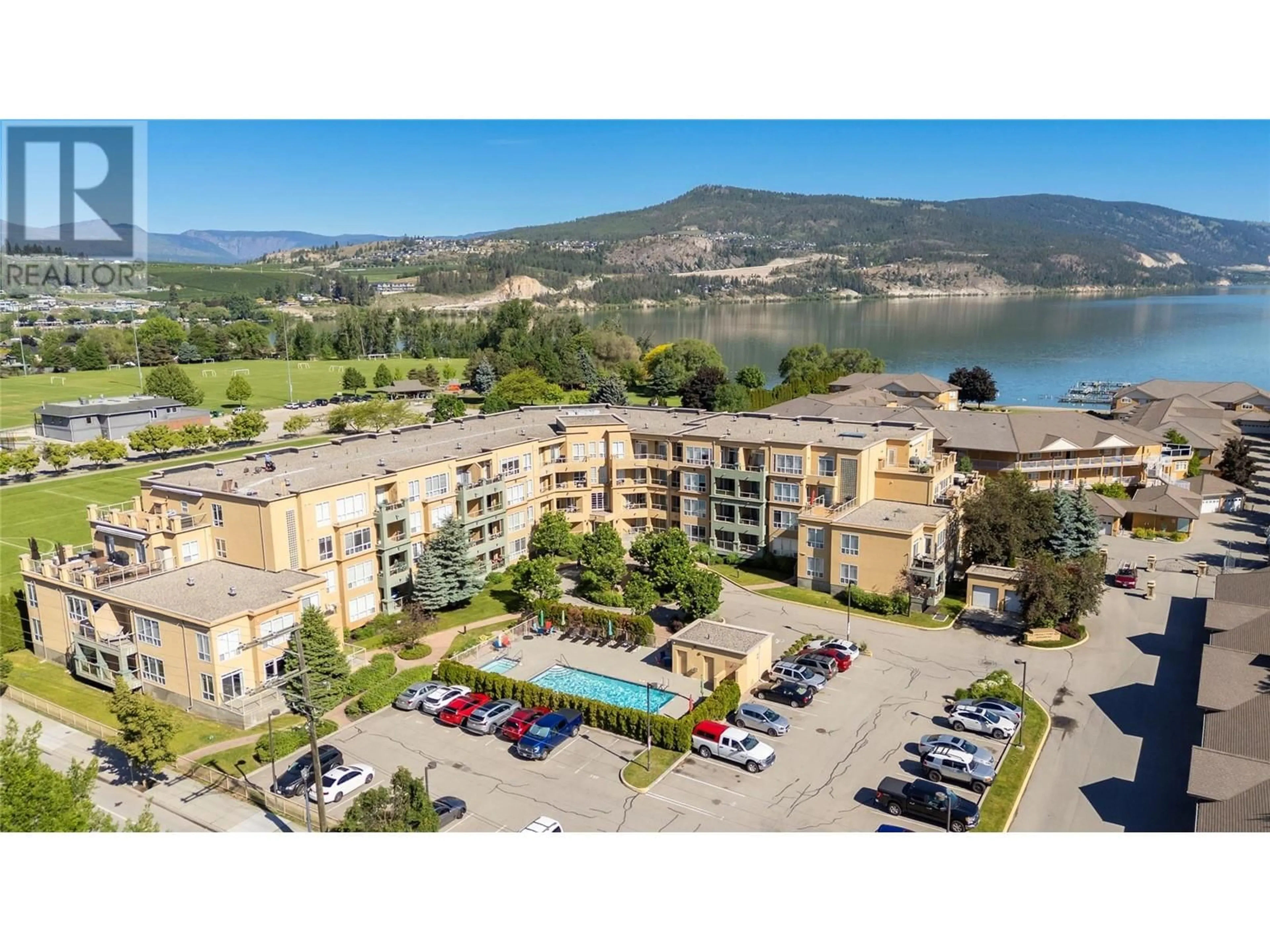 A pic from outside/outdoor area/front of a property/back of a property/a pic from drone, water/lake/river/ocean view for 212 - 3550 WOODSDALE ROAD, Lake Country British Columbia V4V2P5