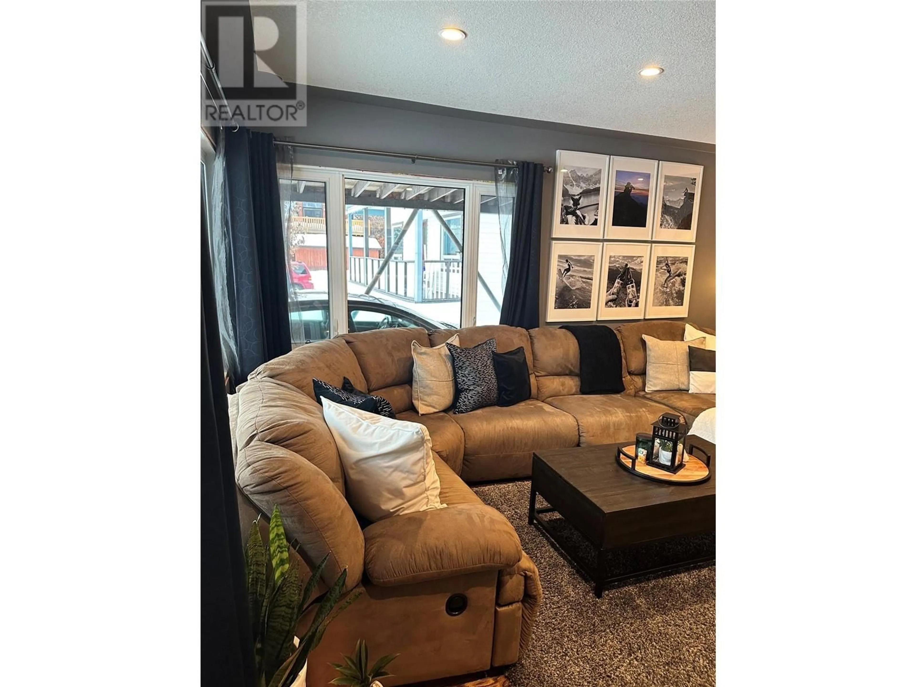 Living room with furniture, wood/laminate floor for 562 6TH AVENUE, Fernie British Columbia V0B1M0