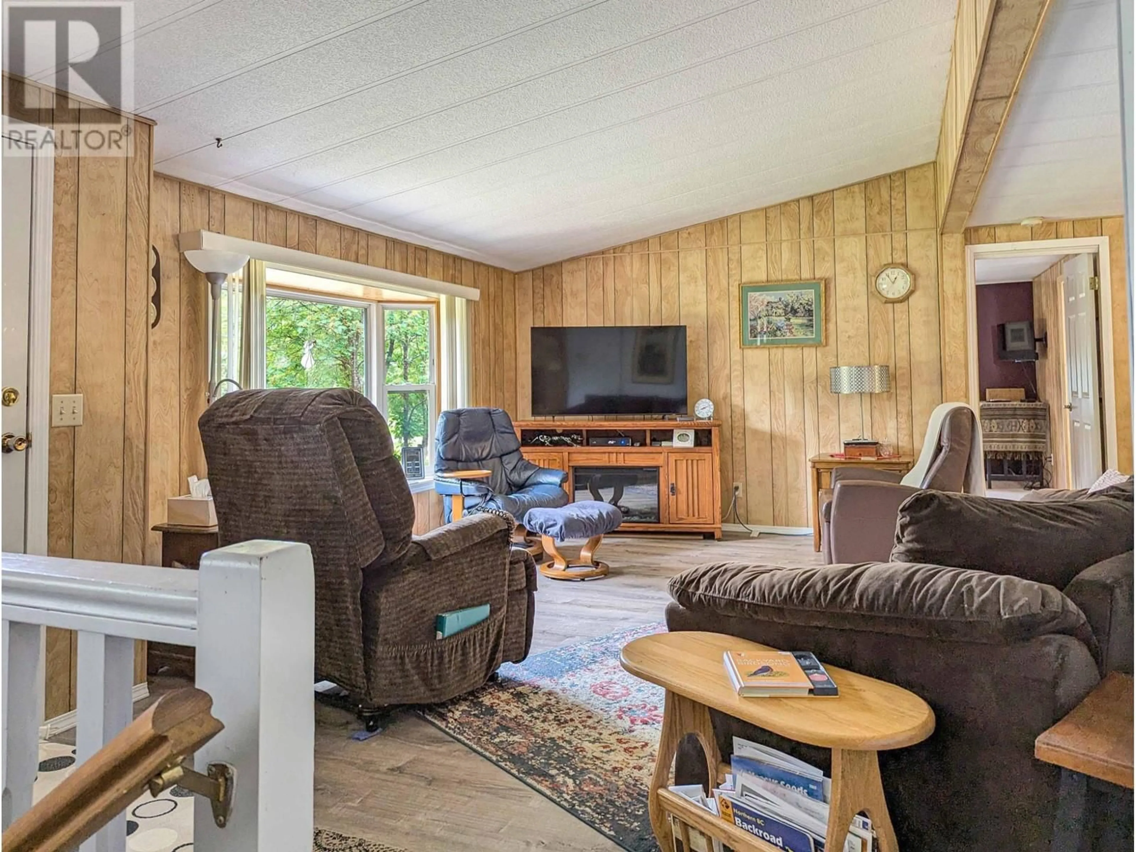 Living room with furniture, wood/laminate floor for 1132 CAROLINE ROAD, Clearwater British Columbia V0E1N2