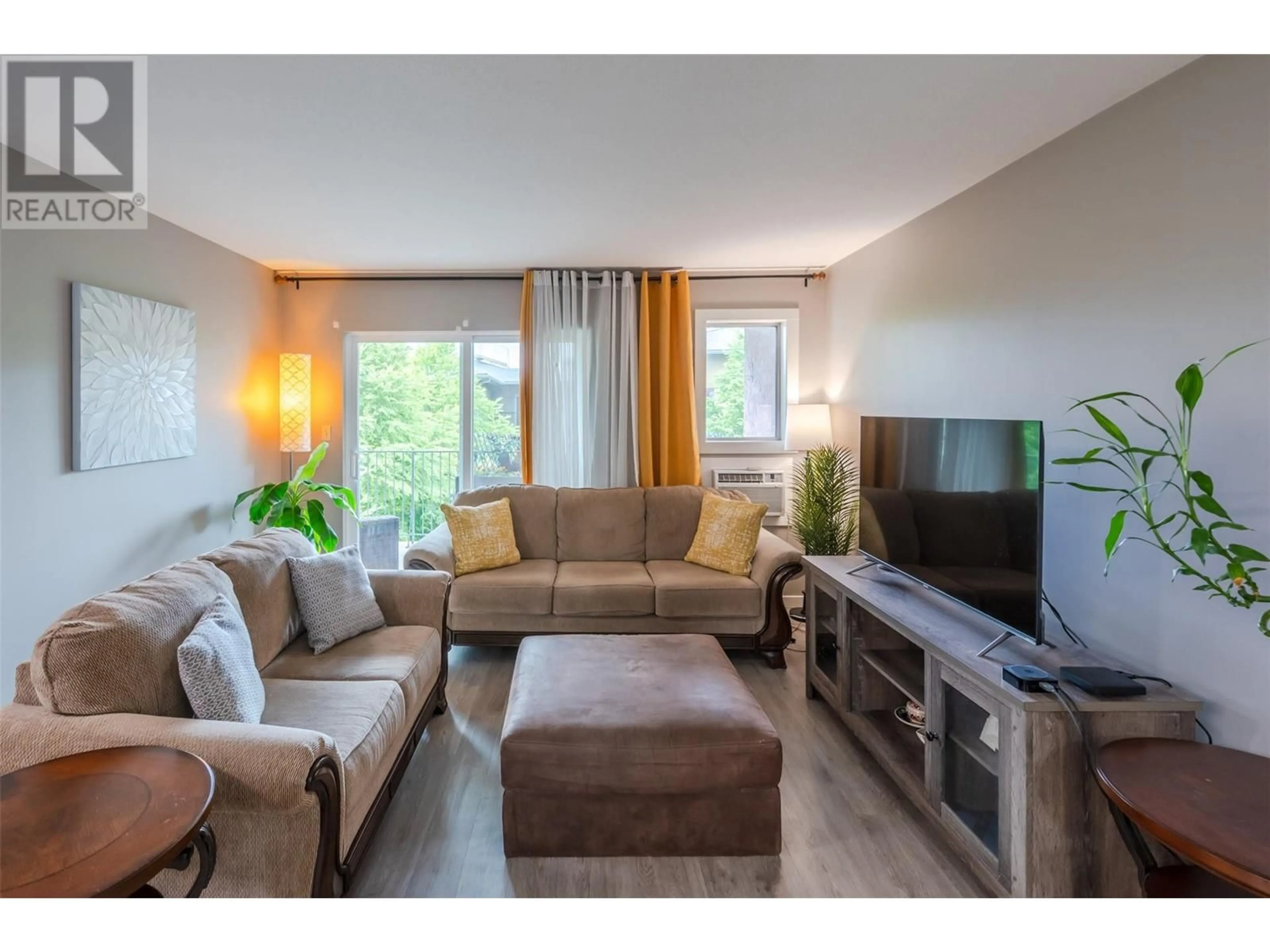 Living room with furniture, wood/laminate floor for 309 - 3426 HEMLOCK STREET, Penticton British Columbia V2A8K1