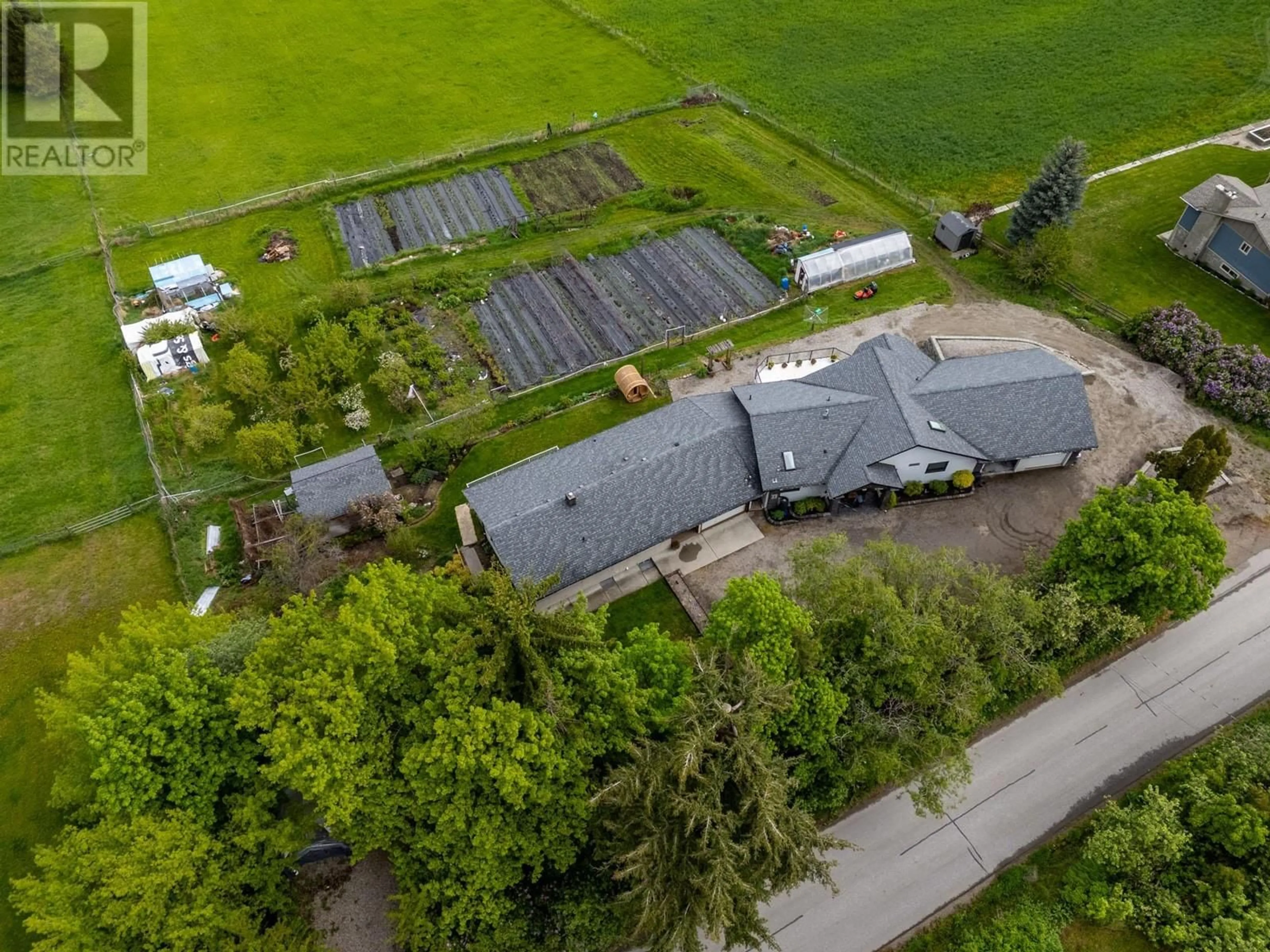 A pic from outside/outdoor area/front of a property/back of a property/a pic from drone, street for 5585 REID ROAD, Coldstream British Columbia V1B3E8
