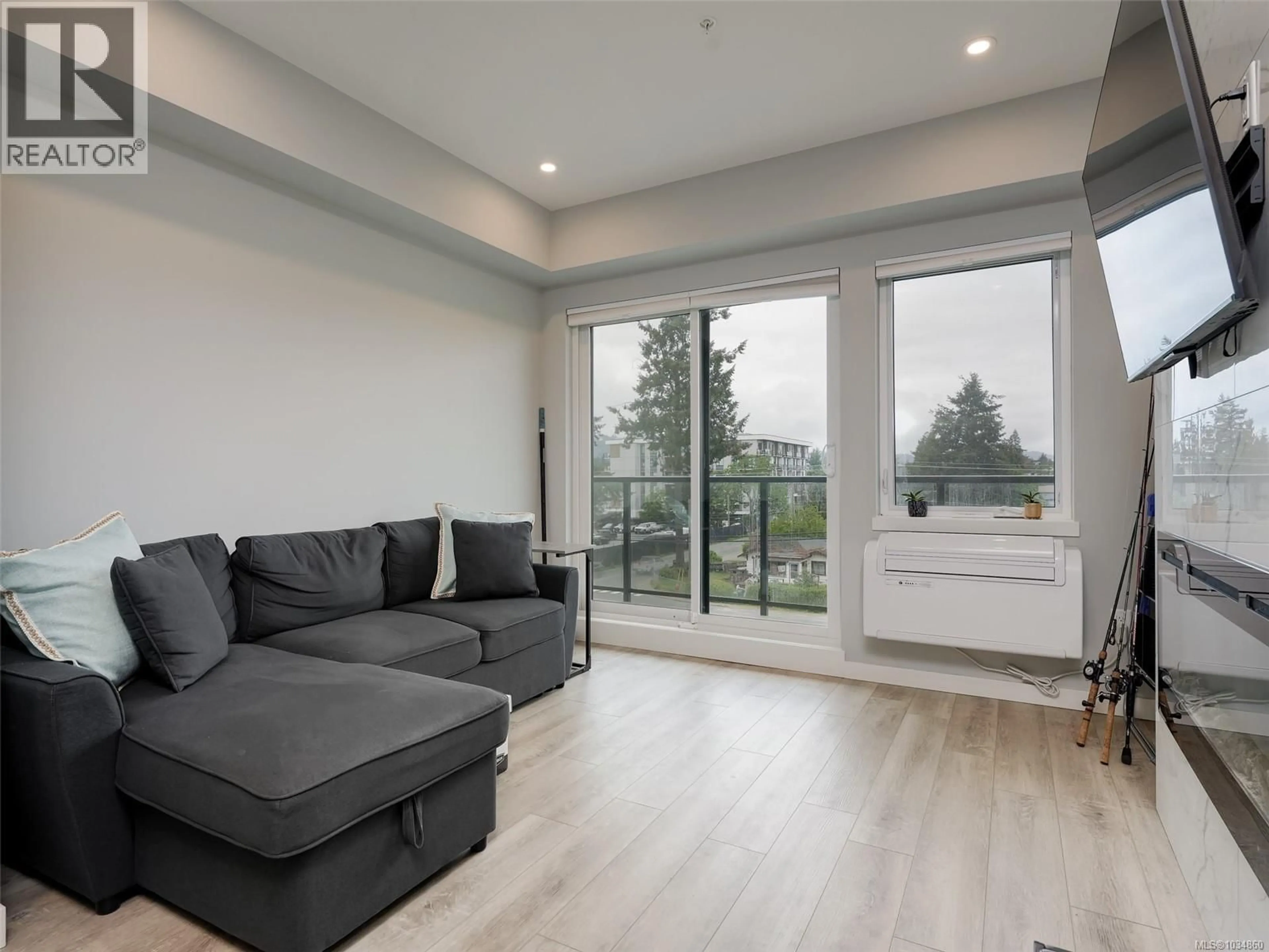 Living room with furniture, wood/laminate floor for 404 - 654 GRANDERSON ROAD, Langford British Columbia V9B7B9