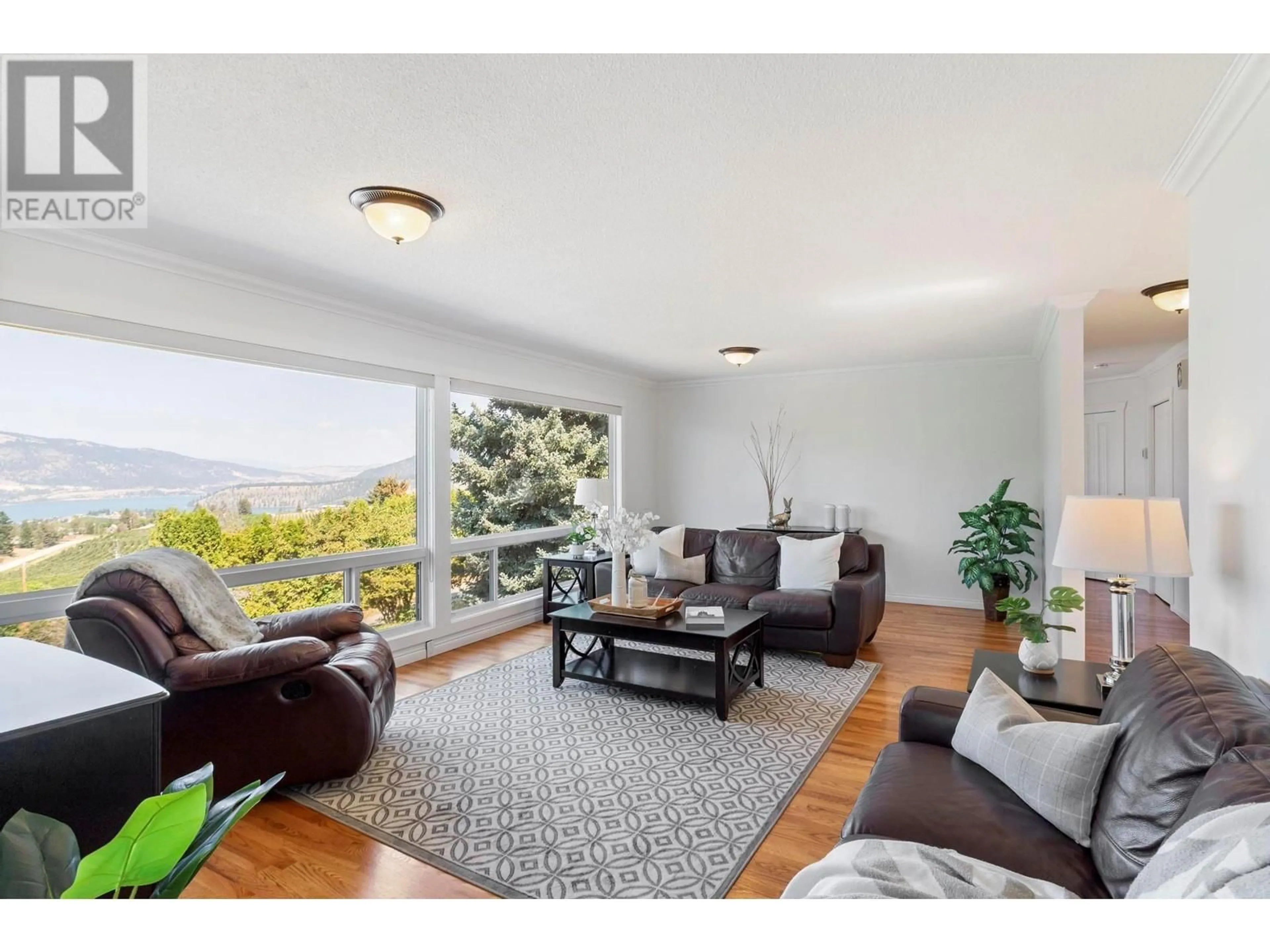 Living room with furniture, wood/laminate floor for 14251 EAST HILL ROAD, Lake Country British Columbia V4V2B9