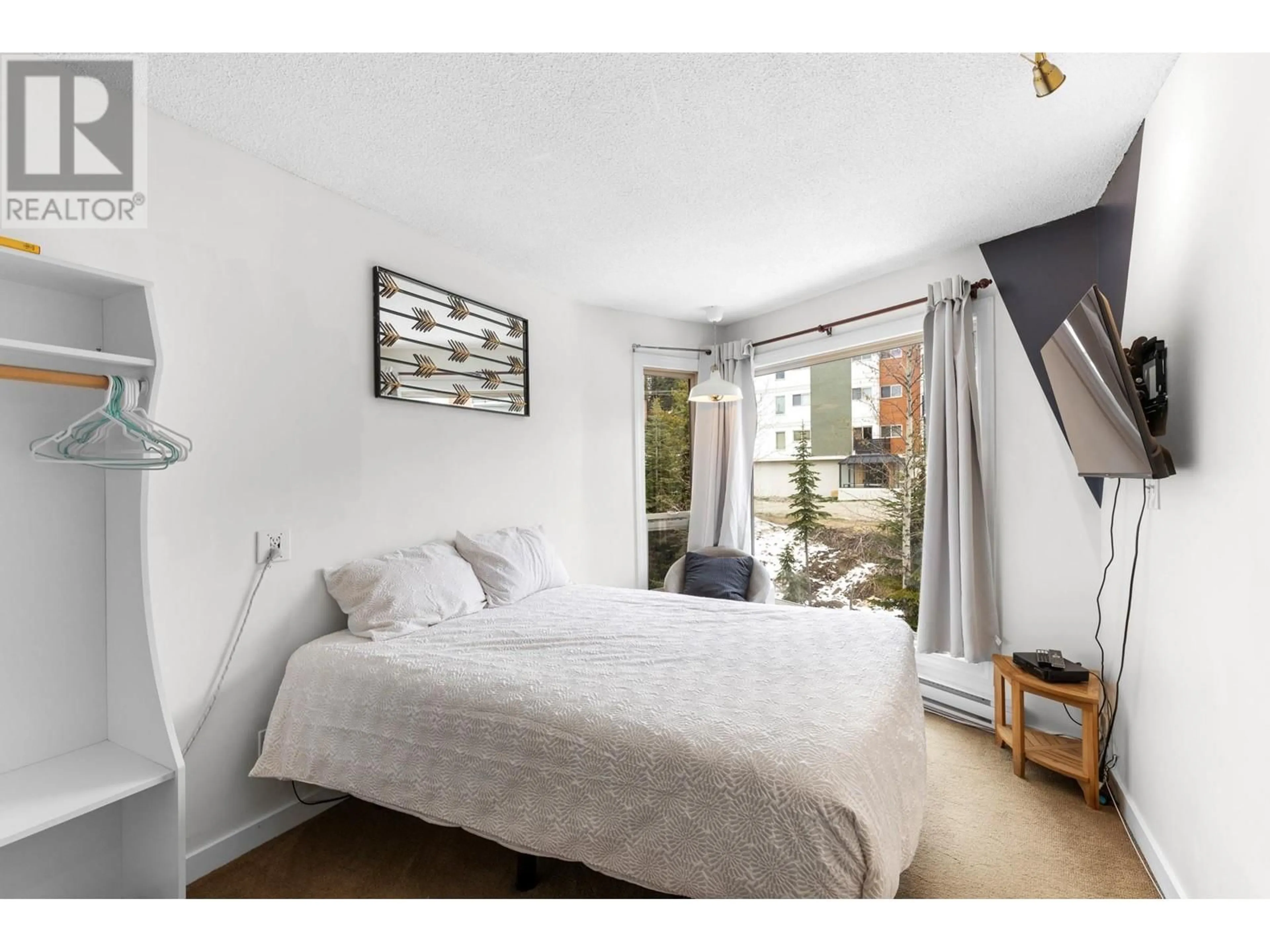 Bedroom with bed, wood/laminate floor for 204 - 5375 BIG WHITE ROAD, Big White British Columbia V1P1T4