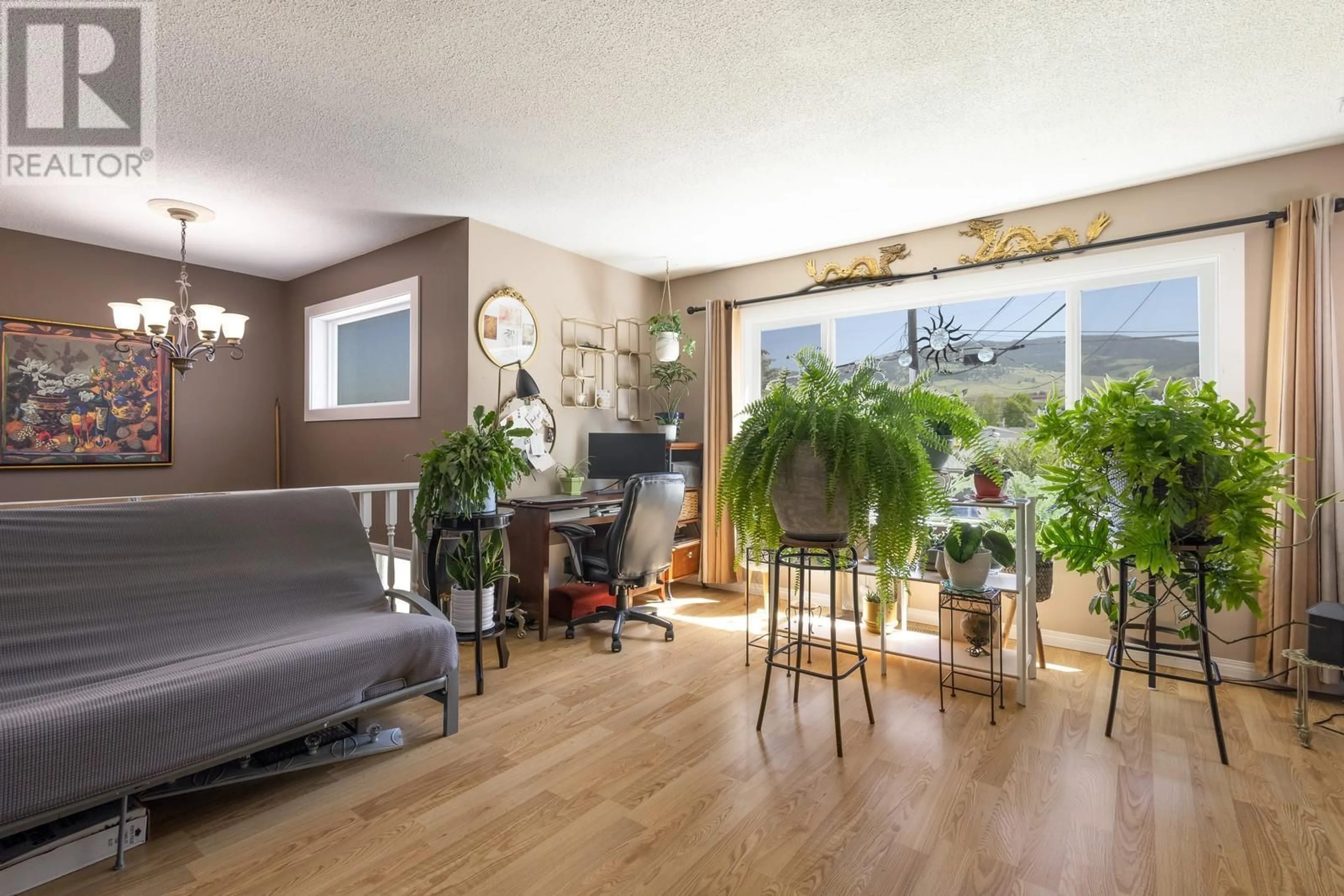 Living room with furniture, wood/laminate floor for 150 SADLER ROAD, Kelowna British Columbia V1X2Y7
