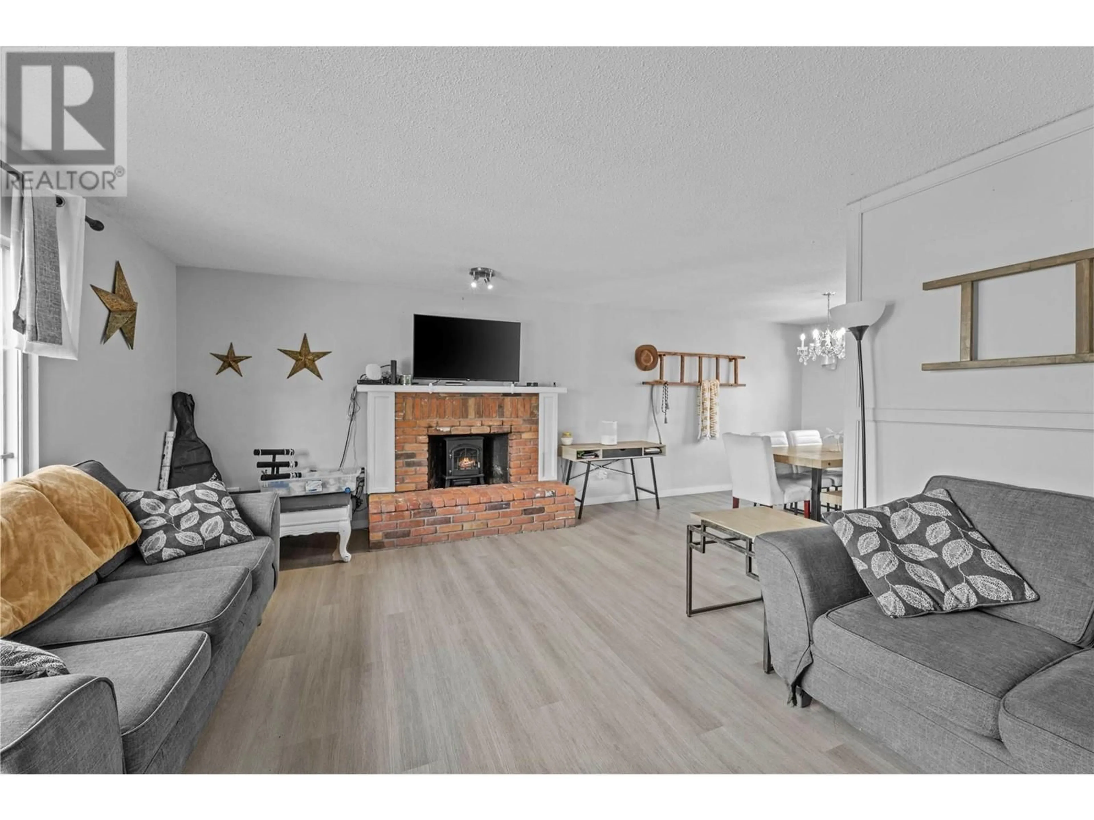 Living room with furniture, wood/laminate floor for 787 GLENEAGLES DRIVE, Kamloops British Columbia V2E1J7