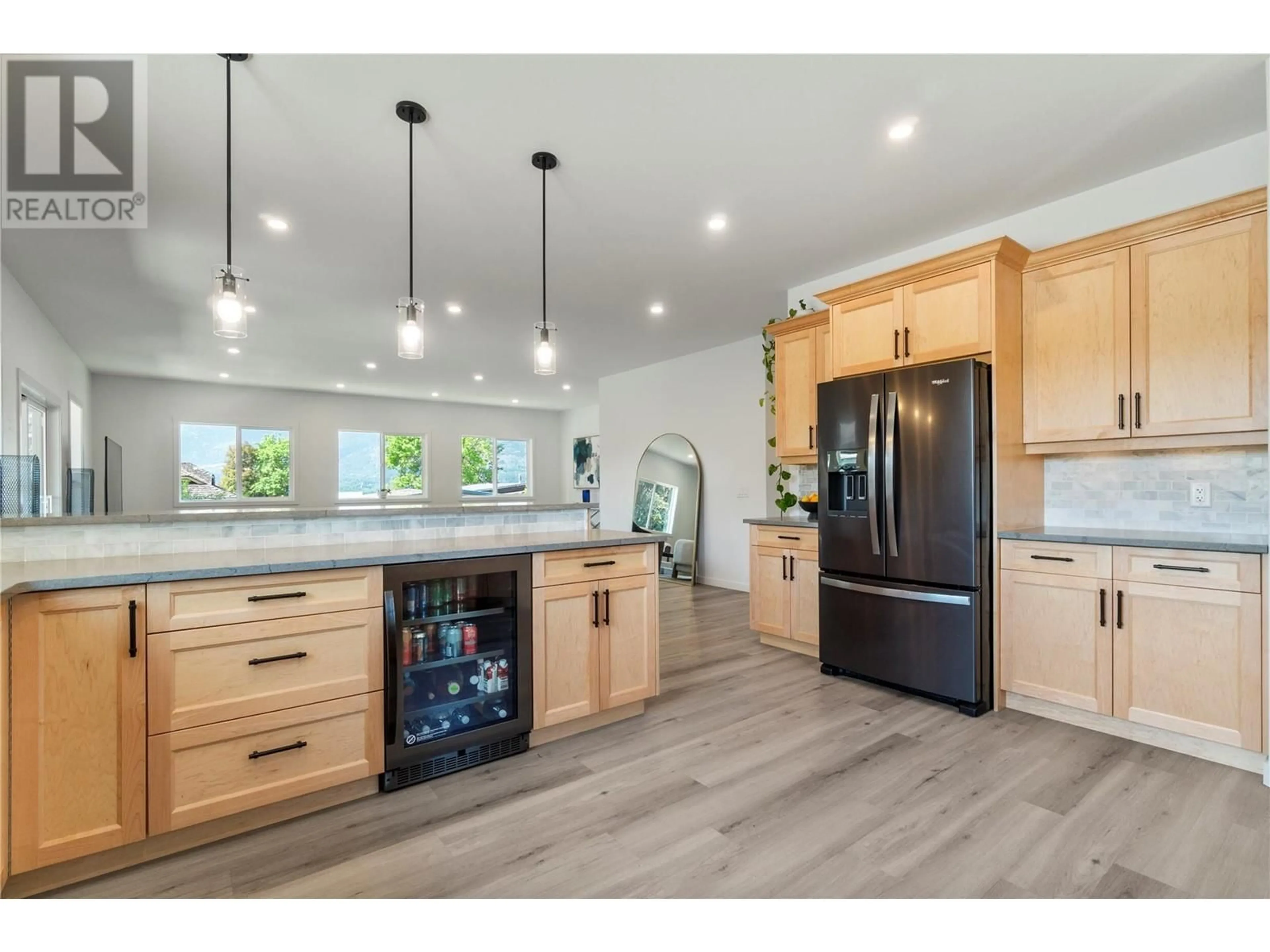 Open concept kitchen, wood/laminate floor for 1240 52 AVENUE, Salmon Arm British Columbia V1E3M8