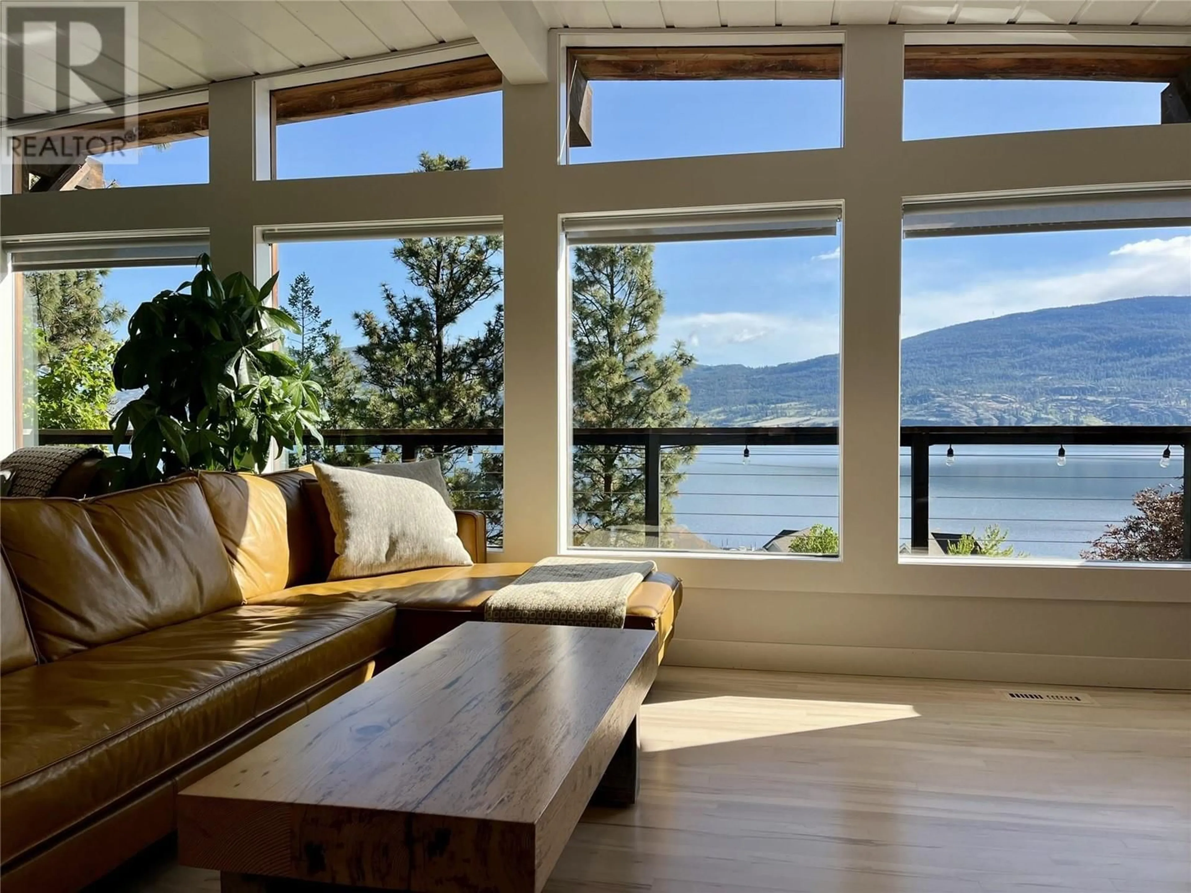 Living room with furniture, wood/laminate floor for 15415 POHLMAN AVENUE, Summerland British Columbia V0H1Z6