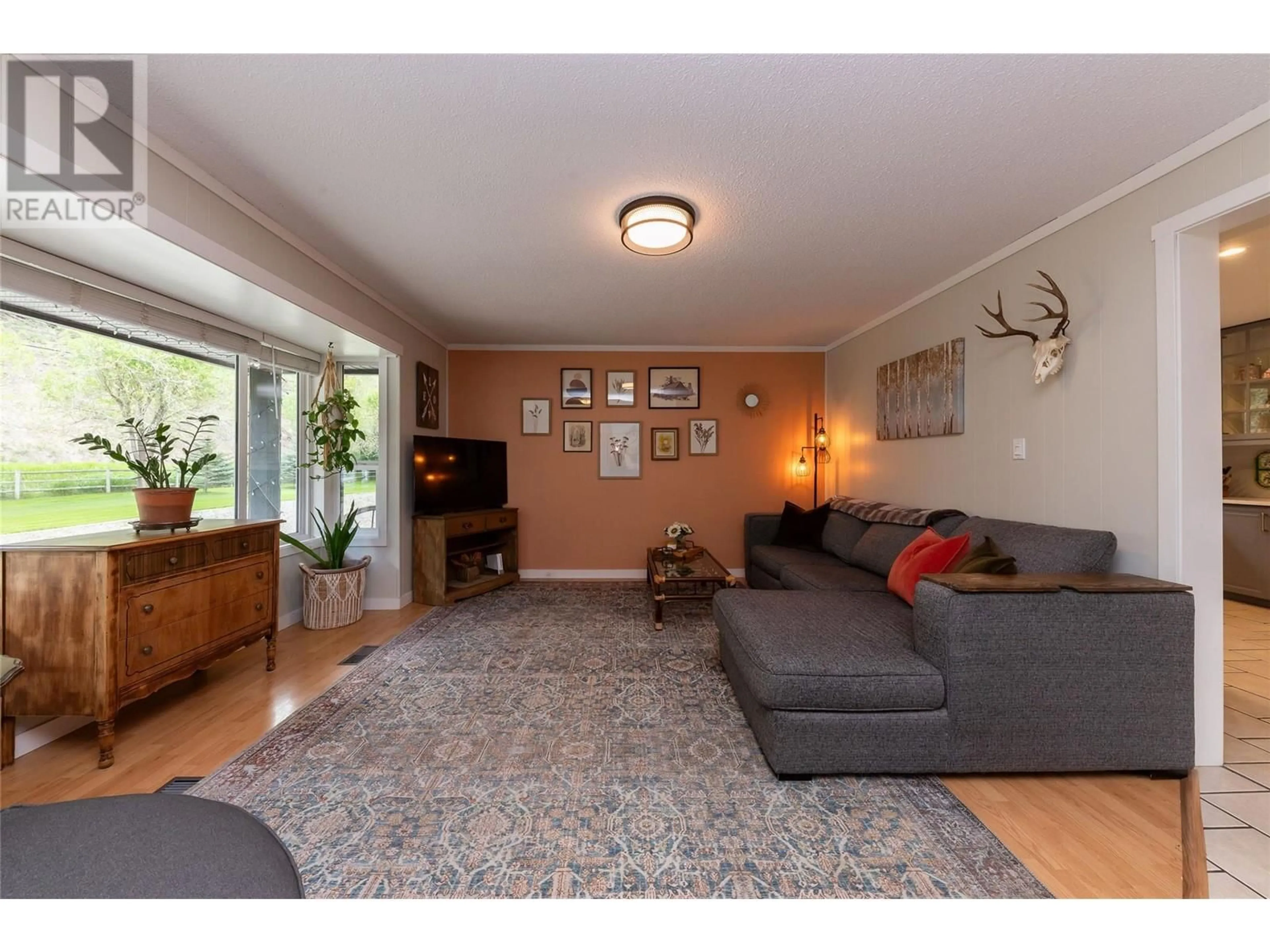 Living room with furniture, wood/laminate floor for 3602 KAMLOOPS VERNON HIGHWAY, Monte Lake British Columbia V0E2N0