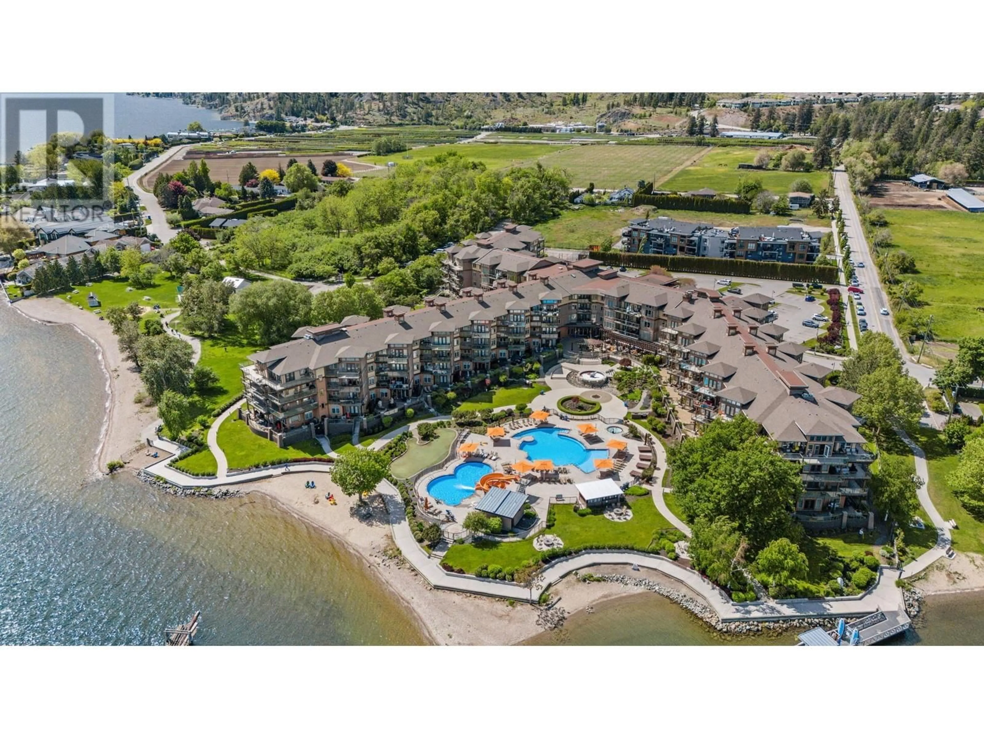 A pic from outside/outdoor area/front of a property/back of a property/a pic from drone, water/lake/river/ocean view for 311 - 4205 GELLATLY ROAD, West Kelowna British Columbia V4T2K2