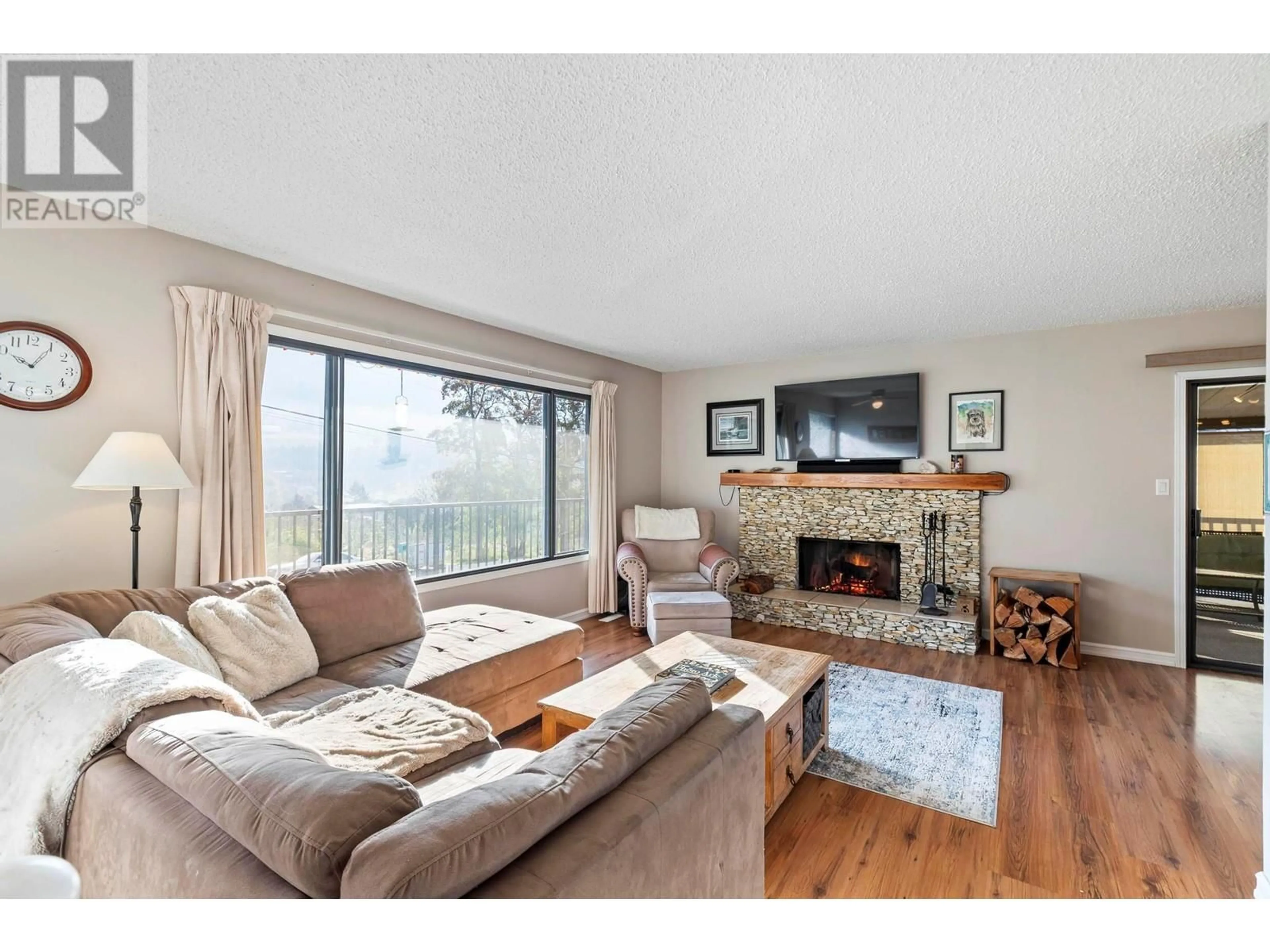 Living room with furniture, wood/laminate floor for 15638 GREENHOW ROAD, Lake Country British Columbia V4V2E7