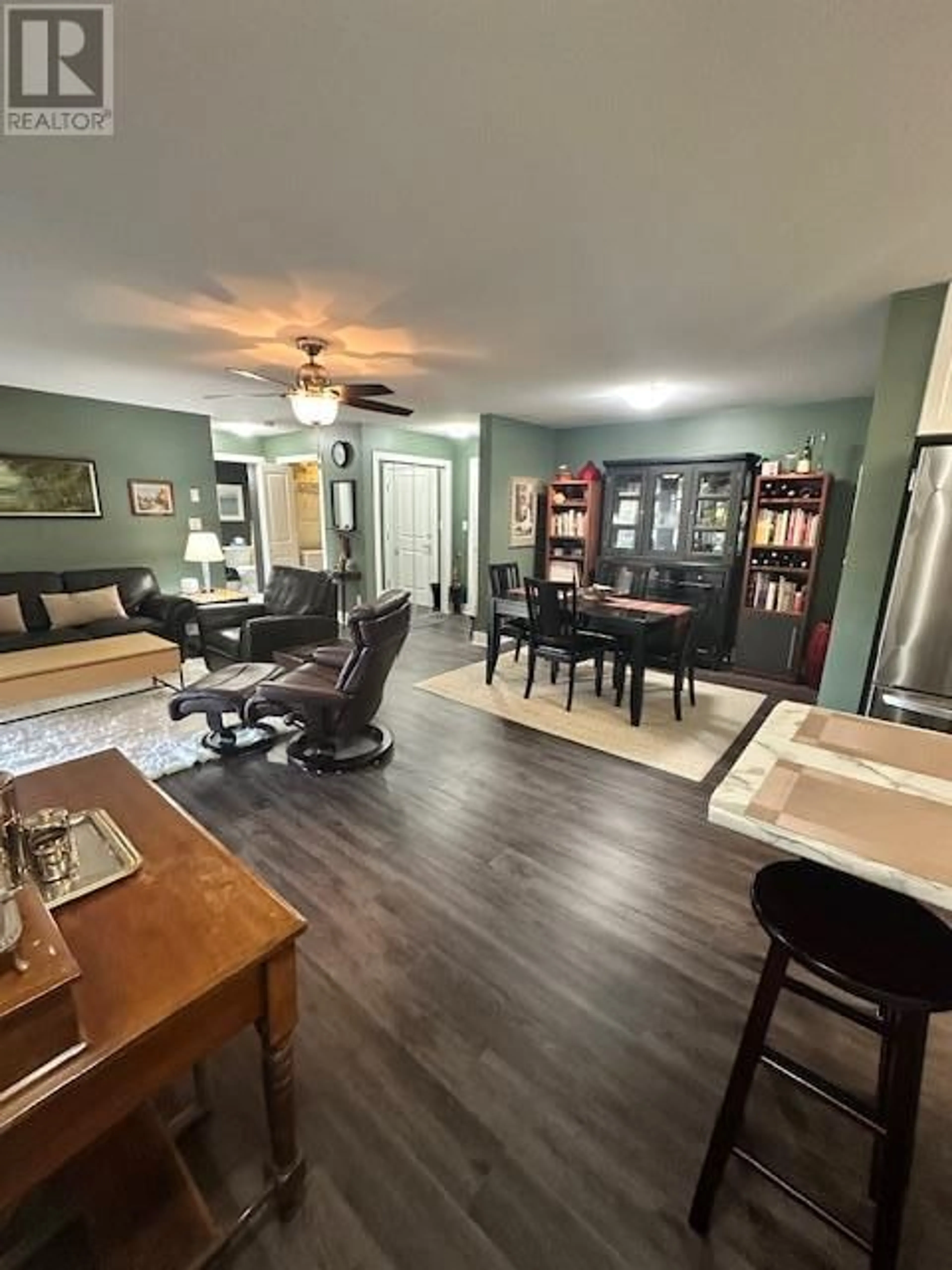 Living room with furniture, wood/laminate floor for 402 - 256 HASTINGS AVENUE, Penticton British Columbia V2A2V6