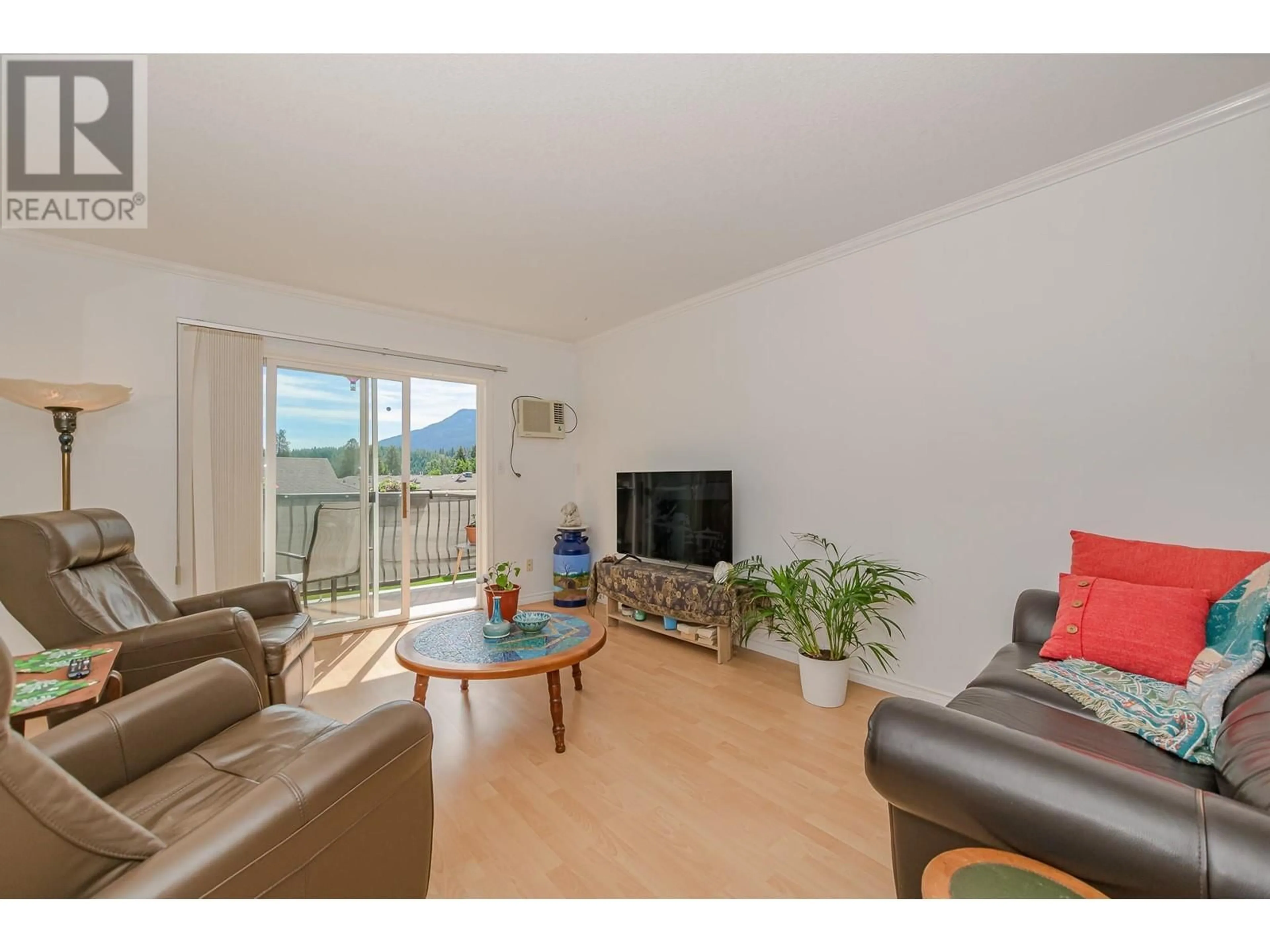 Living room with furniture, wood/laminate floor for 214 - 211 KILDONAN AVENUE, Enderby British Columbia V0E1V2