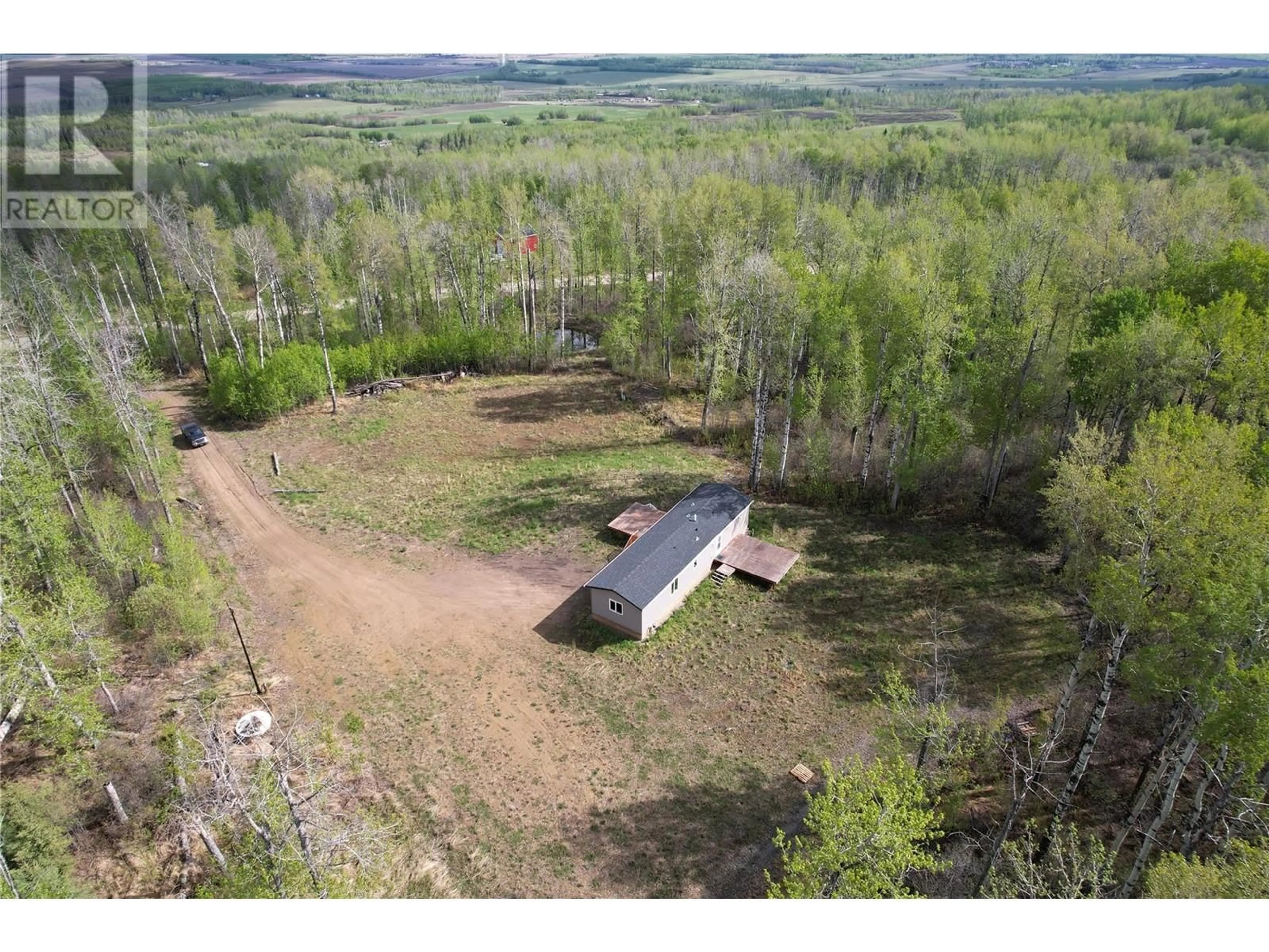 A pic from outside/outdoor area/front of a property/back of a property/a pic from drone, forest/trees view for 129 MOORE WAY, Dawson Creek British Columbia V0C2C0