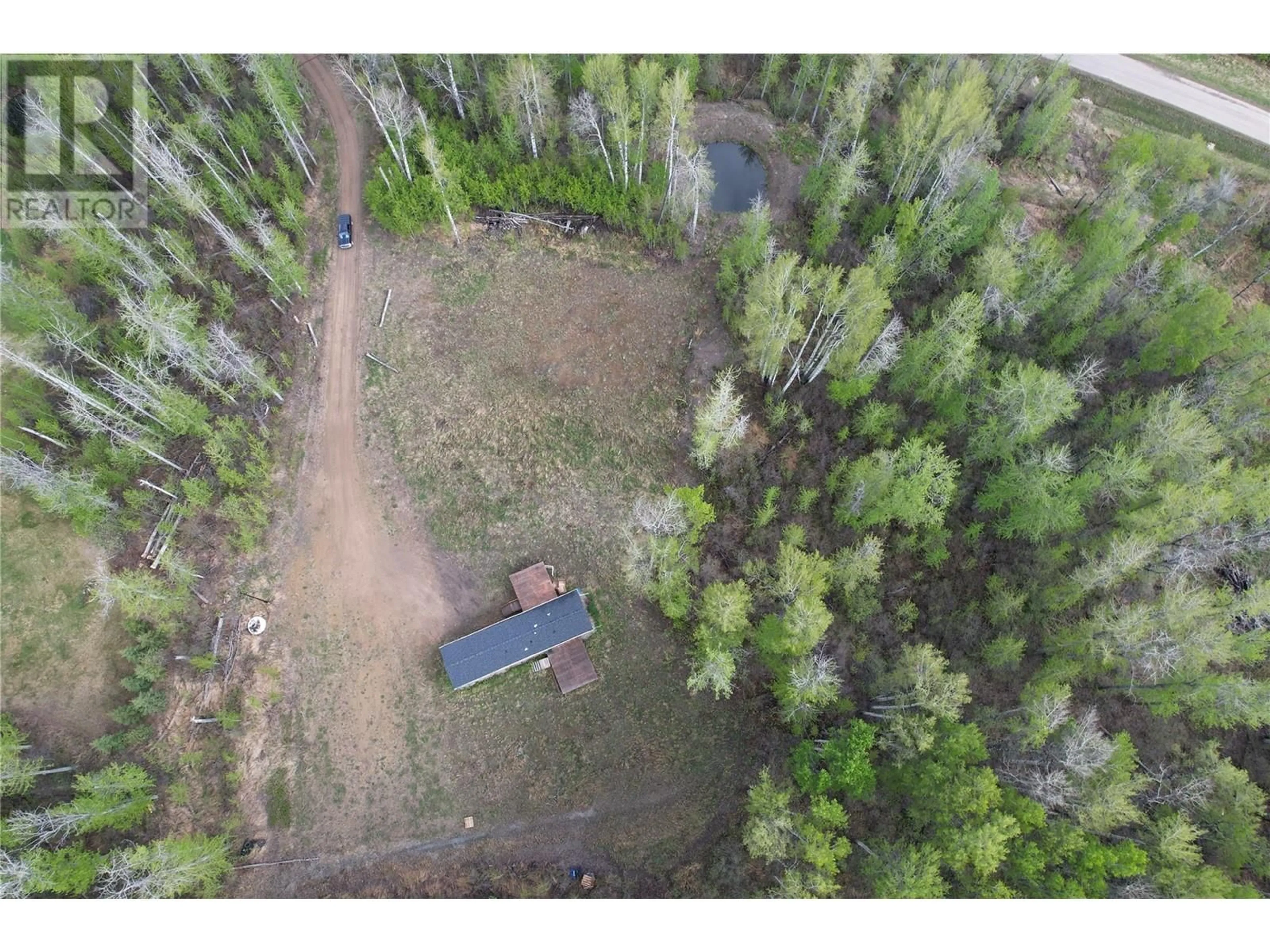 A pic from outside/outdoor area/front of a property/back of a property/a pic from drone, forest/trees view for 129 MOORE WAY, Dawson Creek British Columbia V0C2C0