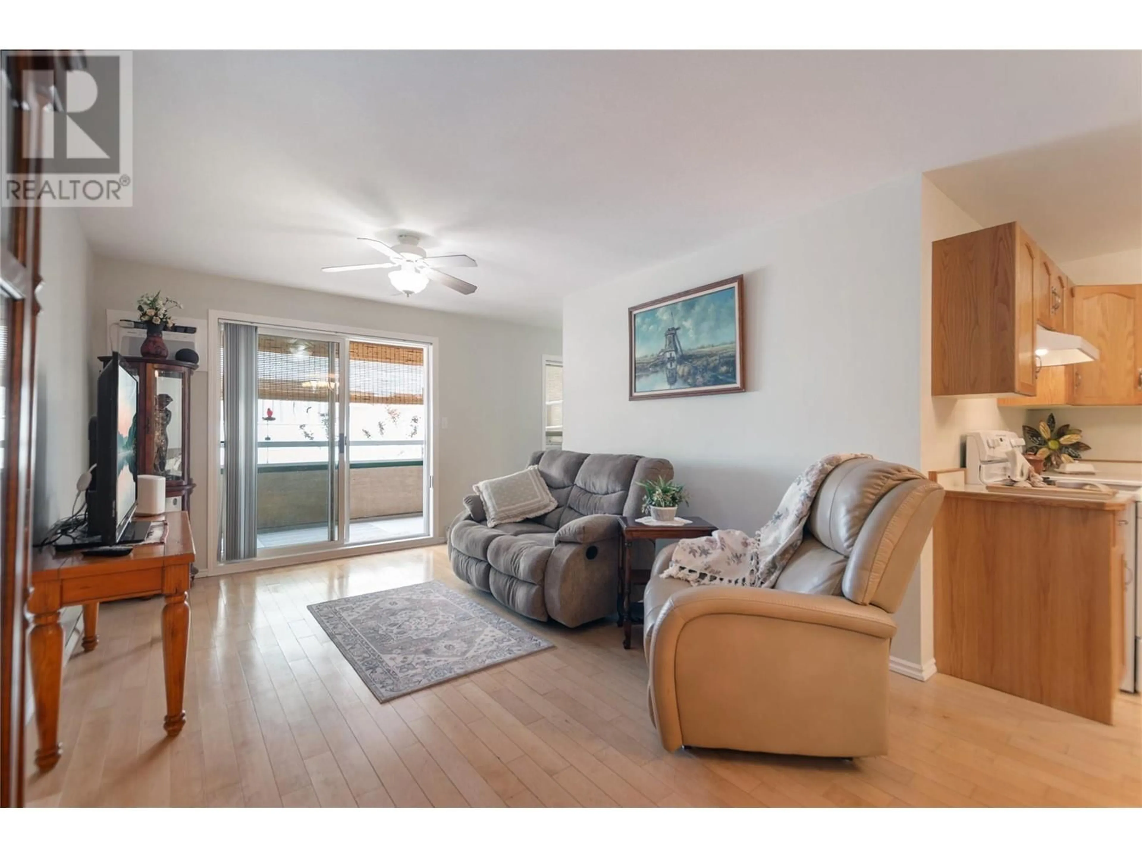 Living room with furniture, wood/laminate floor for 104 - 865 MAIN STREET, Penticton British Columbia V2A5E3