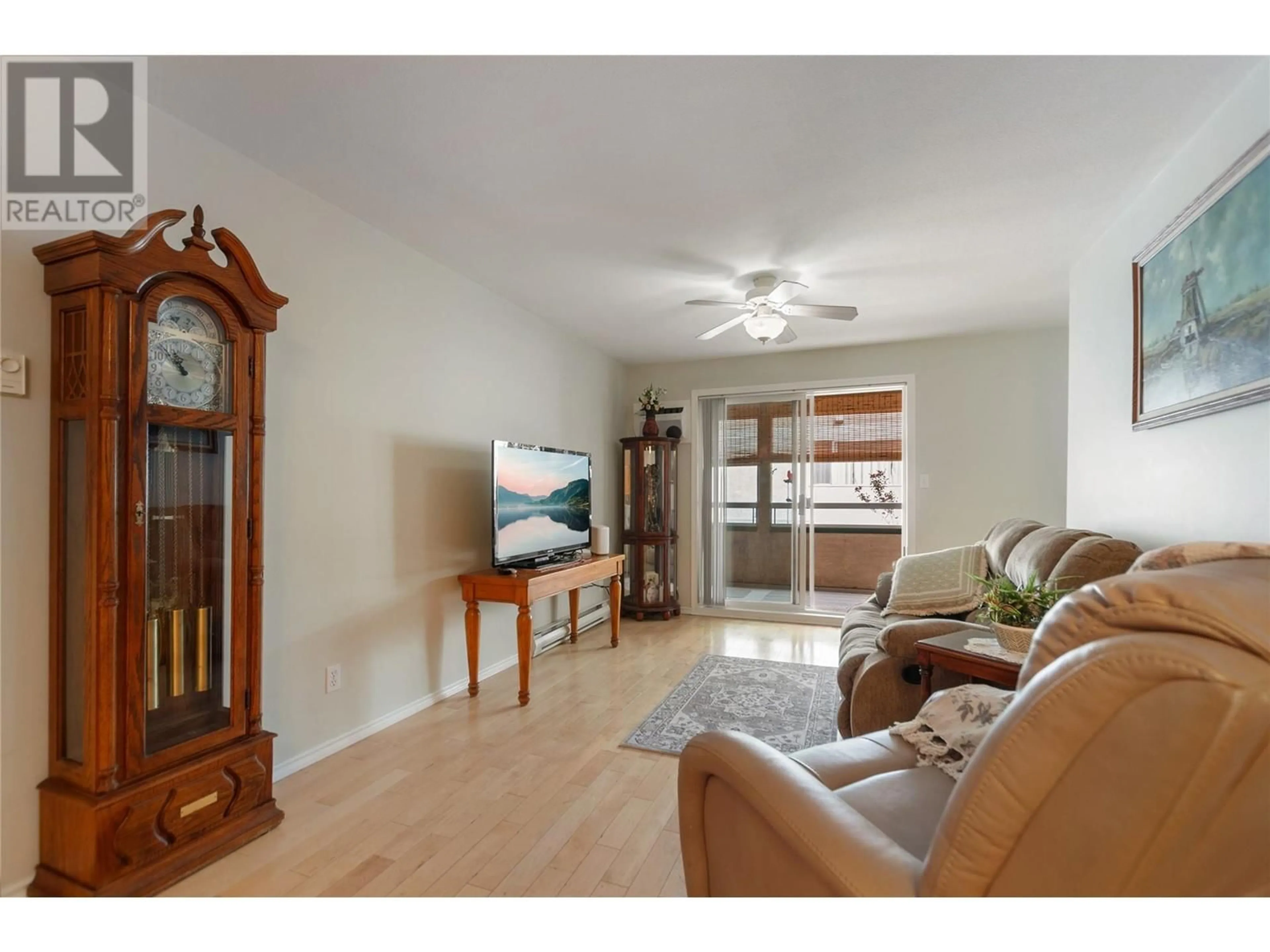 Living room with furniture, wood/laminate floor for 104 - 865 MAIN STREET, Penticton British Columbia V2A5E3