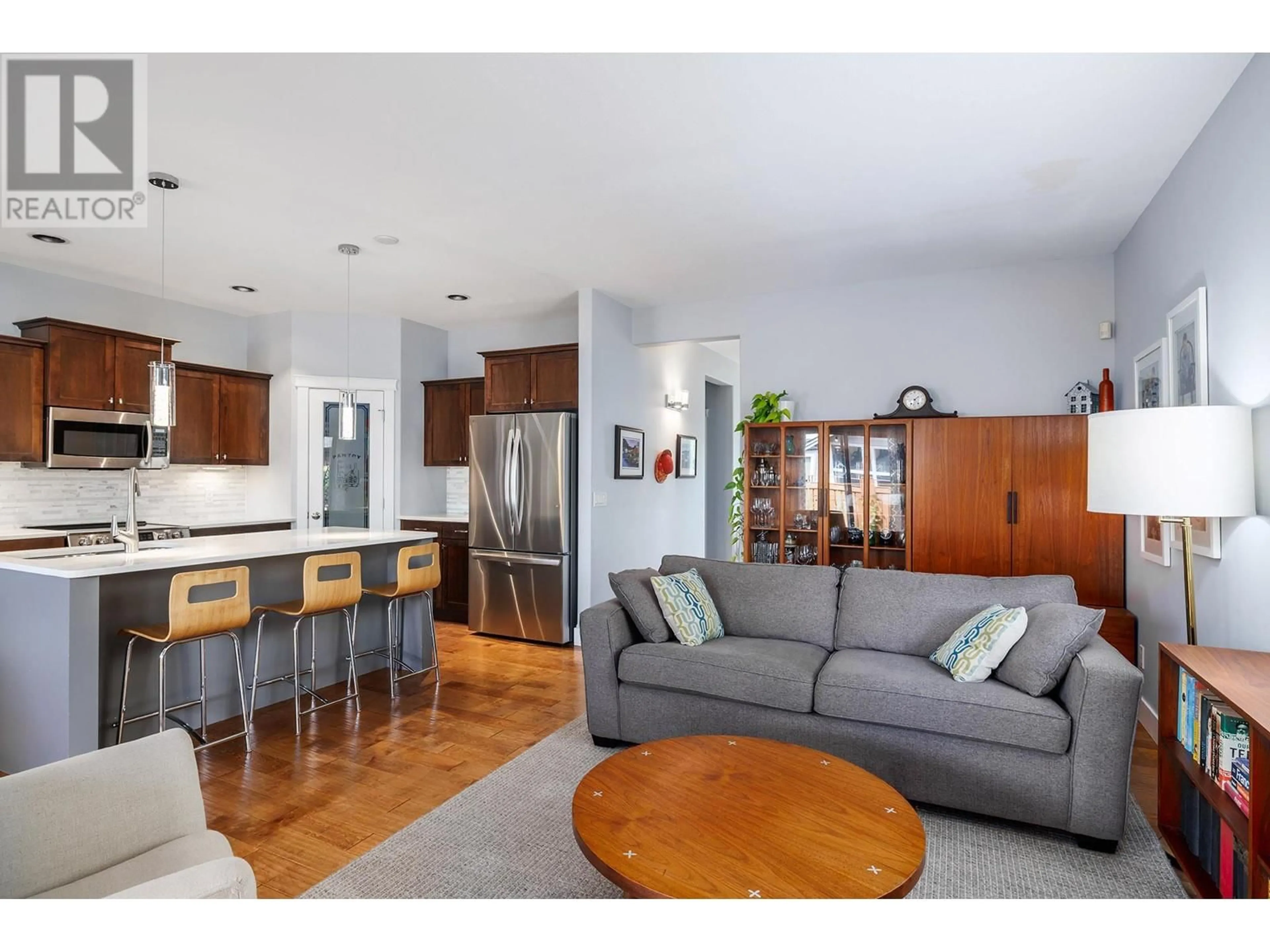 Living room with furniture, wood/laminate floor for 560 LEVITT LANE, Kelowna British Columbia V1Y9Y1