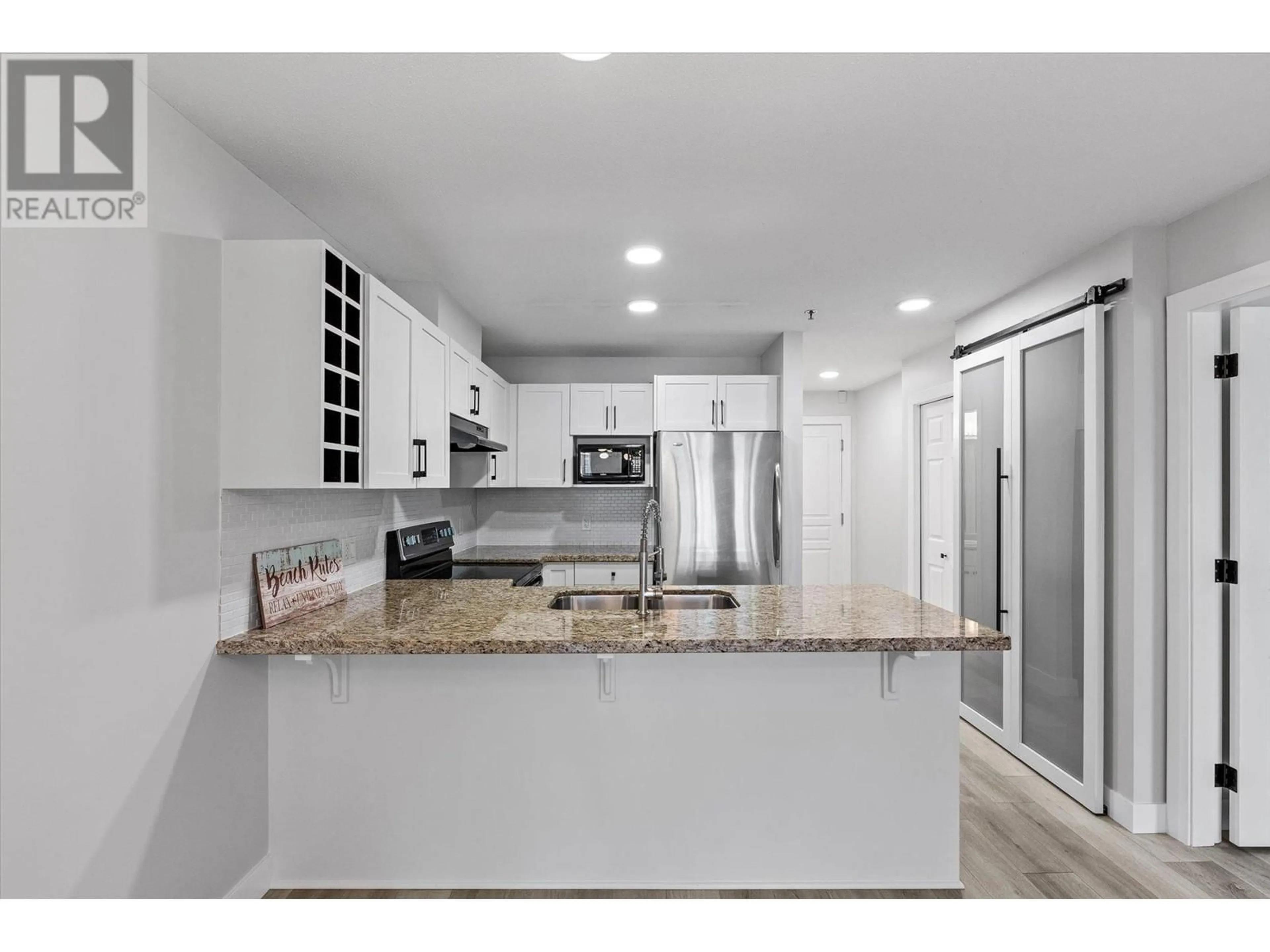 Open concept kitchen, ceramic/tile floor for 319 - 1083 SUNSET DRIVE, Kelowna British Columbia V1Y9Z1