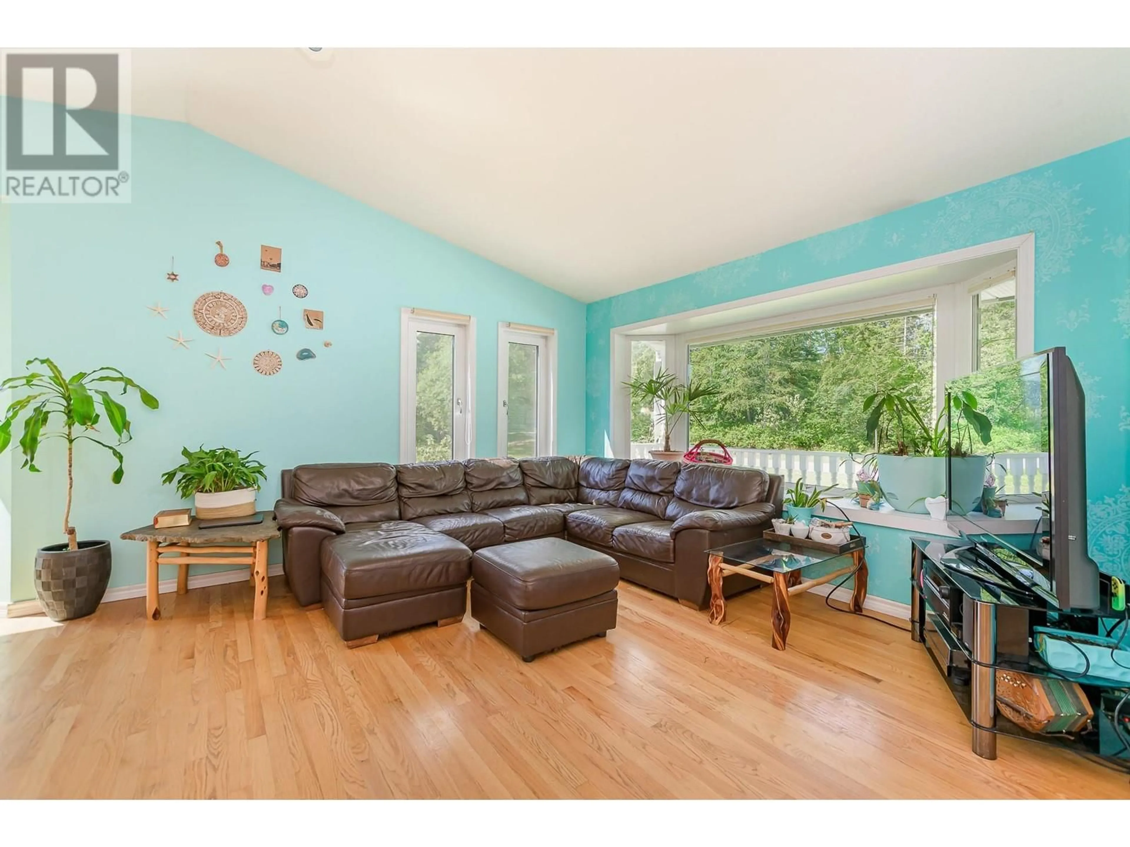 Living room with furniture, wood/laminate floor for 65 GROVE ROAD, Enderby British Columbia V0E1V3