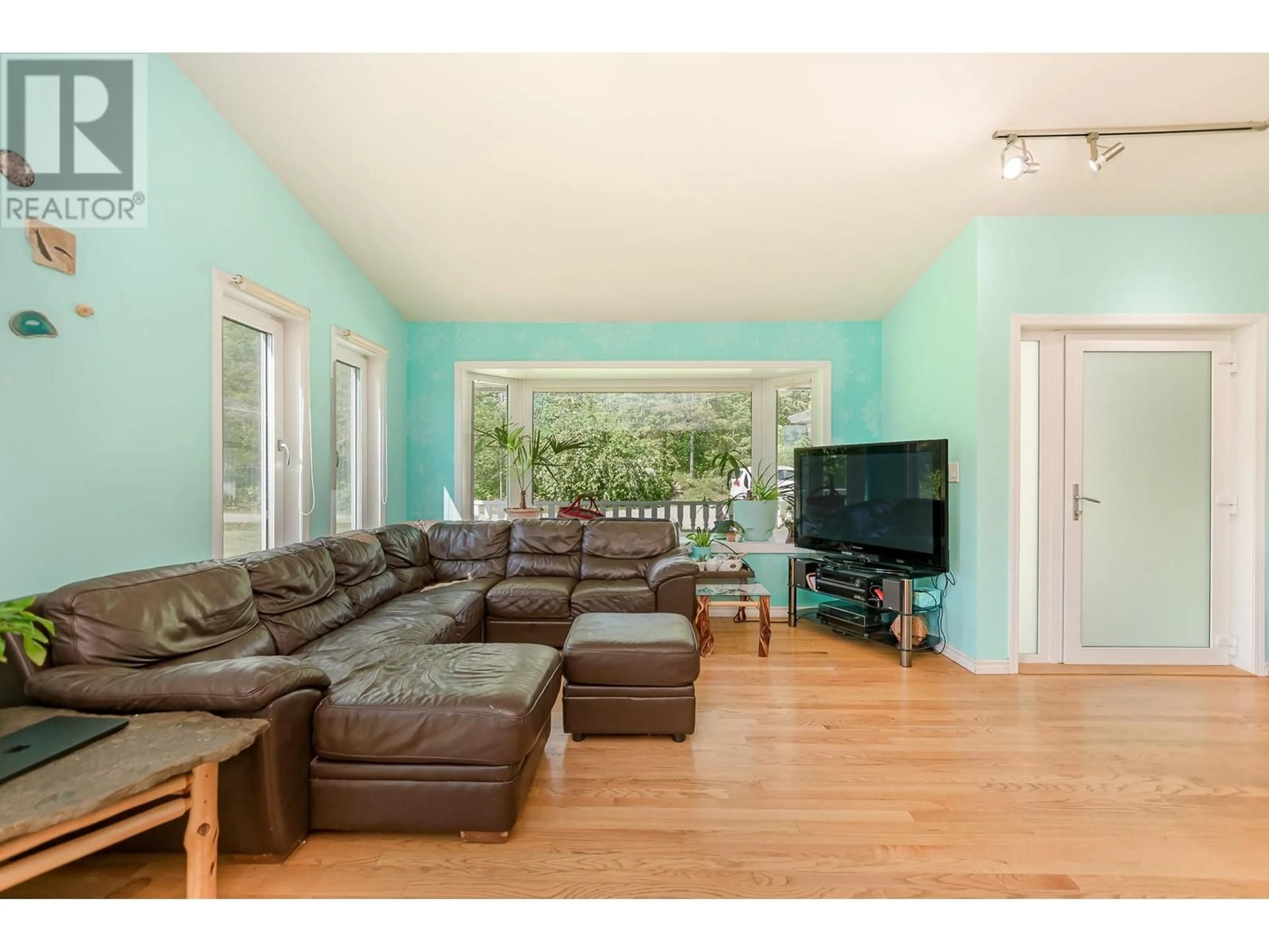Living room with furniture, wood/laminate floor for 65 GROVE ROAD, Enderby British Columbia V0E1V3