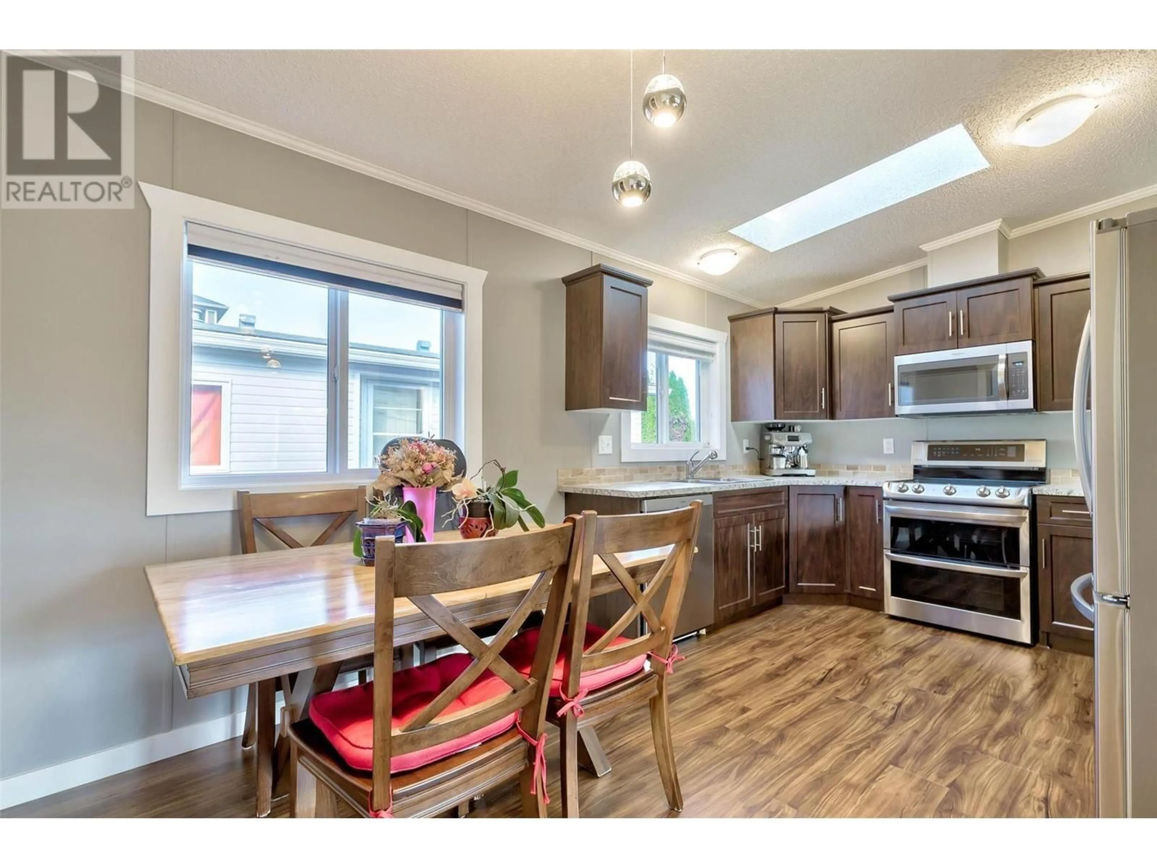 Open concept kitchen, wood/laminate floor for 103 - 5155 CHUTE LAKE ROAD, Kelowna British Columbia V1W4R9