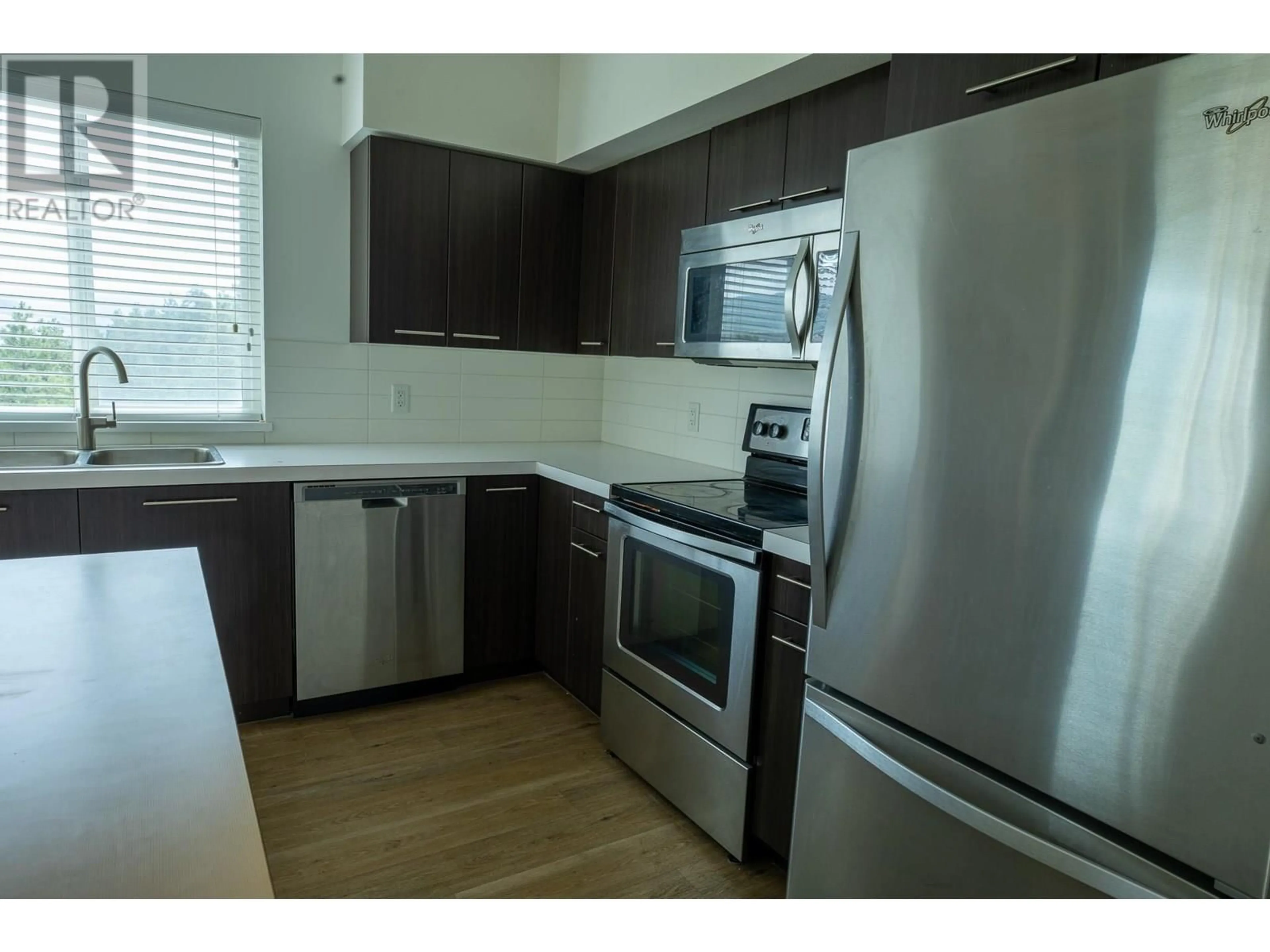 Standard kitchen, wood/laminate floor for 307 - 985 ACADEMY WAY, Kelowna British Columbia V1V3C8
