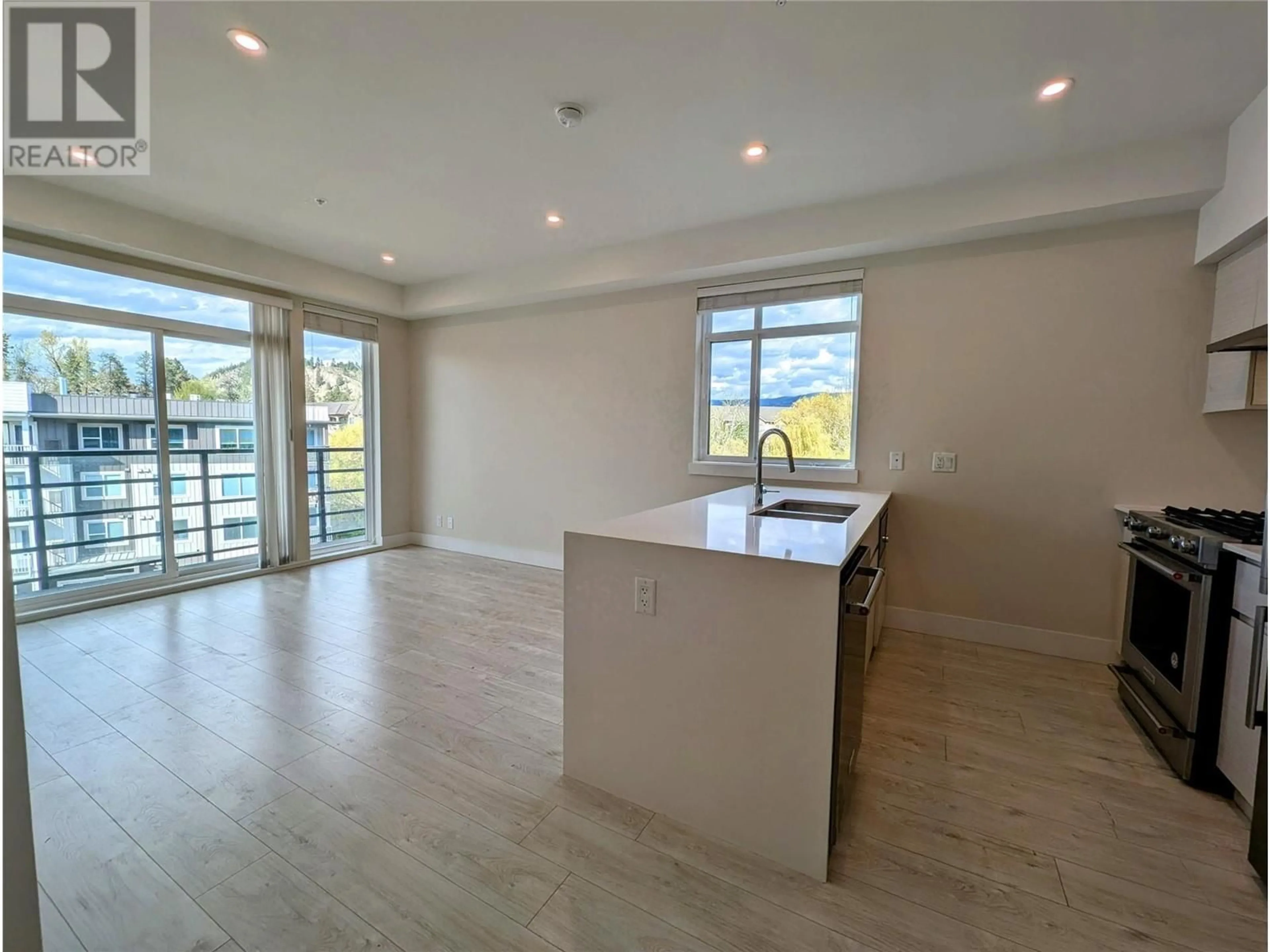 Open concept kitchen, wood/laminate floor for 403 - 1925 ENTERPRISE WAY, Kelowna British Columbia V1Y4P7