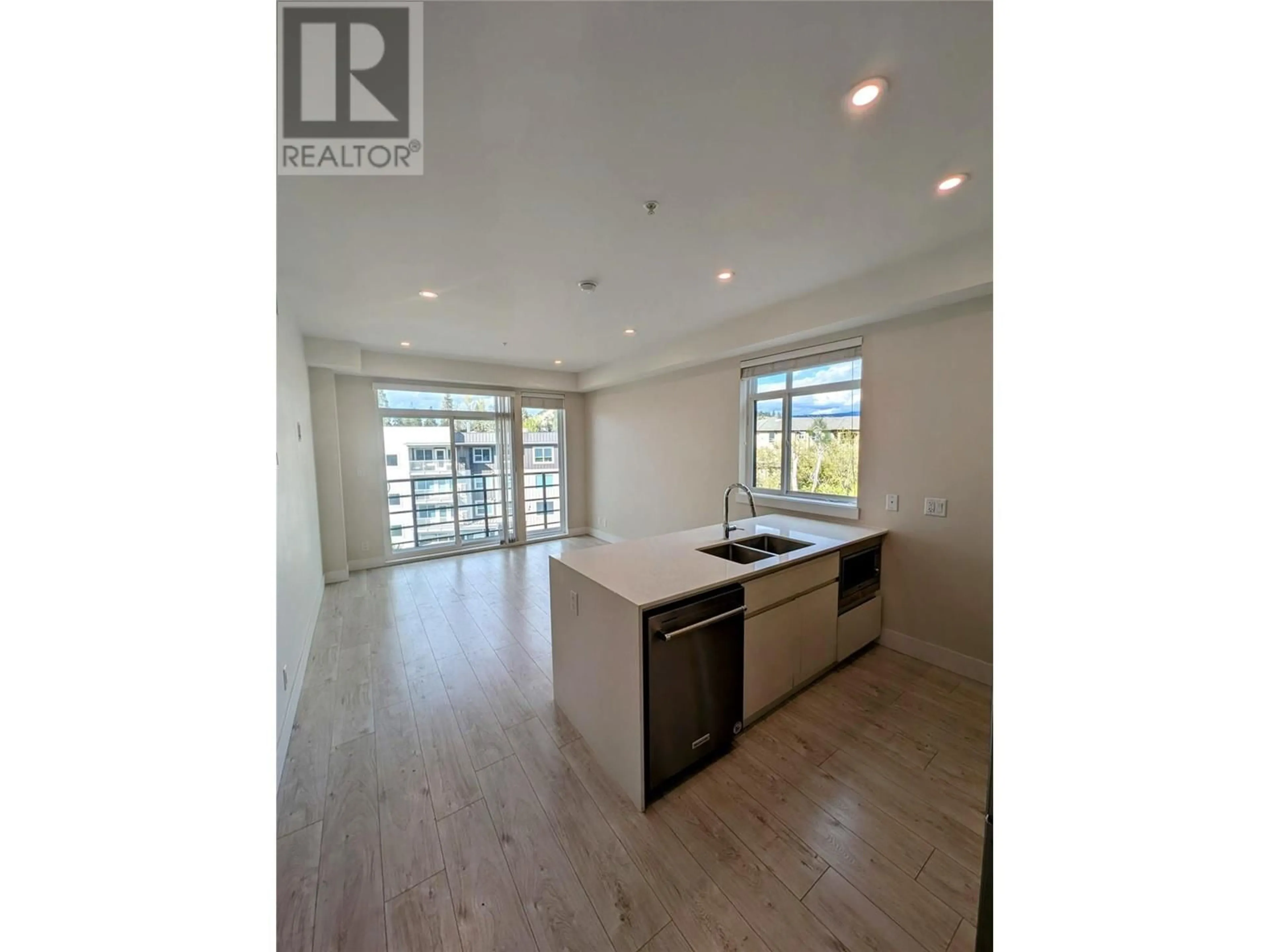 Open concept kitchen, wood/laminate floor for 403 - 1925 ENTERPRISE WAY, Kelowna British Columbia V1Y4P7