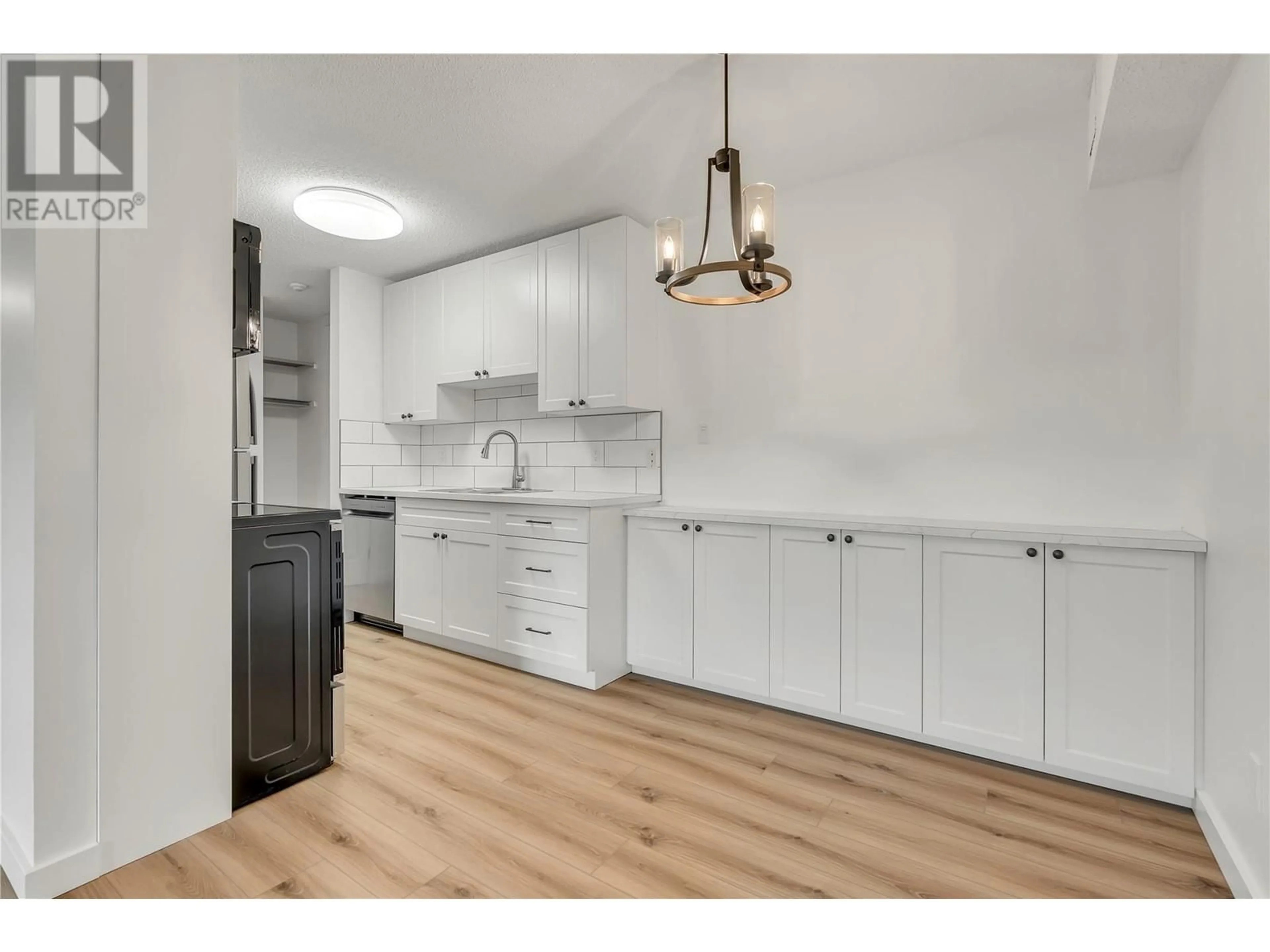 Open concept kitchen, wood/laminate floor for 107 - 110 SKAHA PLACE, Penticton British Columbia V2A7L1