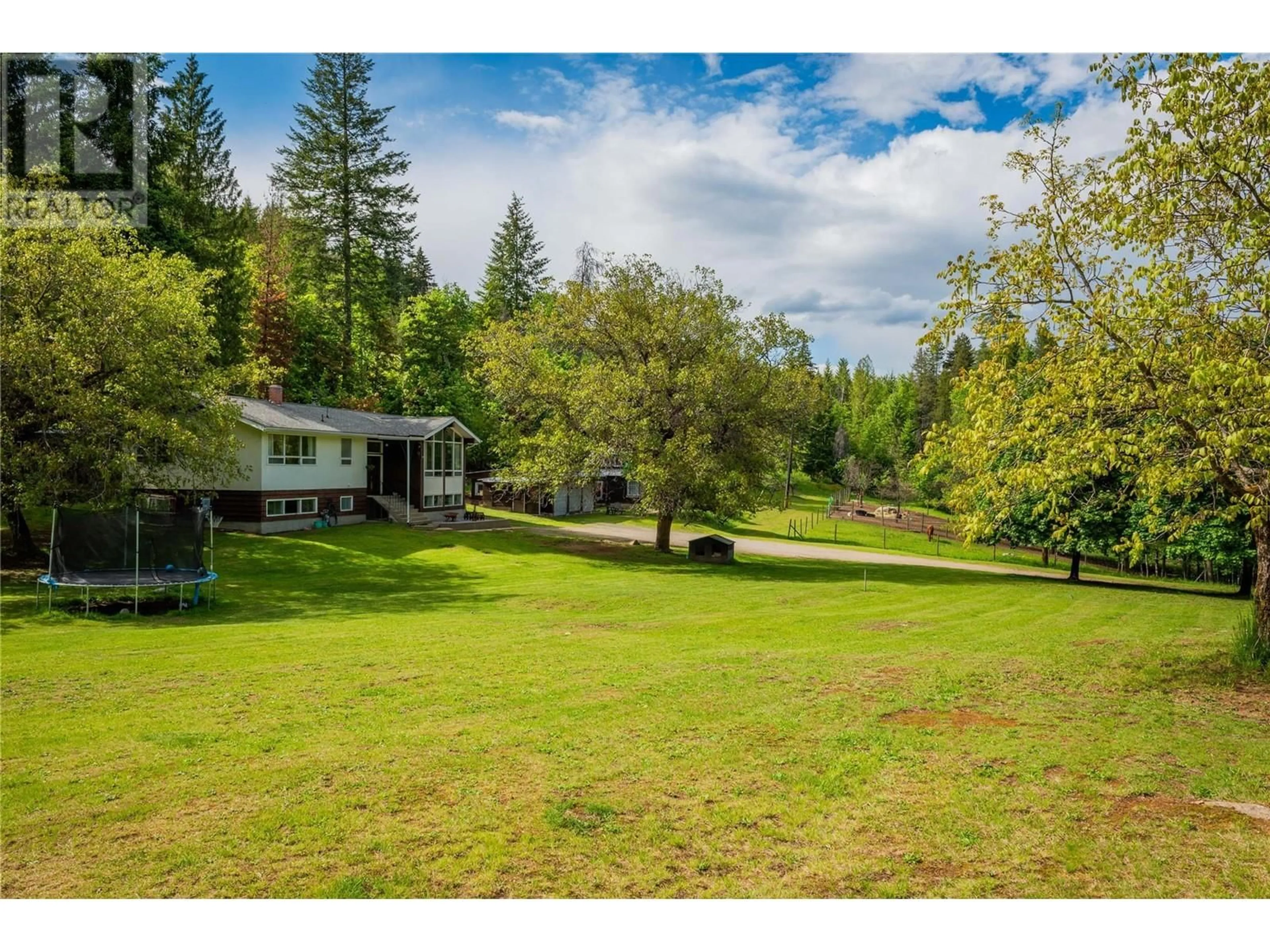 A pic from outside/outdoor area/front of a property/back of a property/a pic from drone, forest/trees view for 1 MASON ROAD, Castlegar British Columbia V1N3Z1