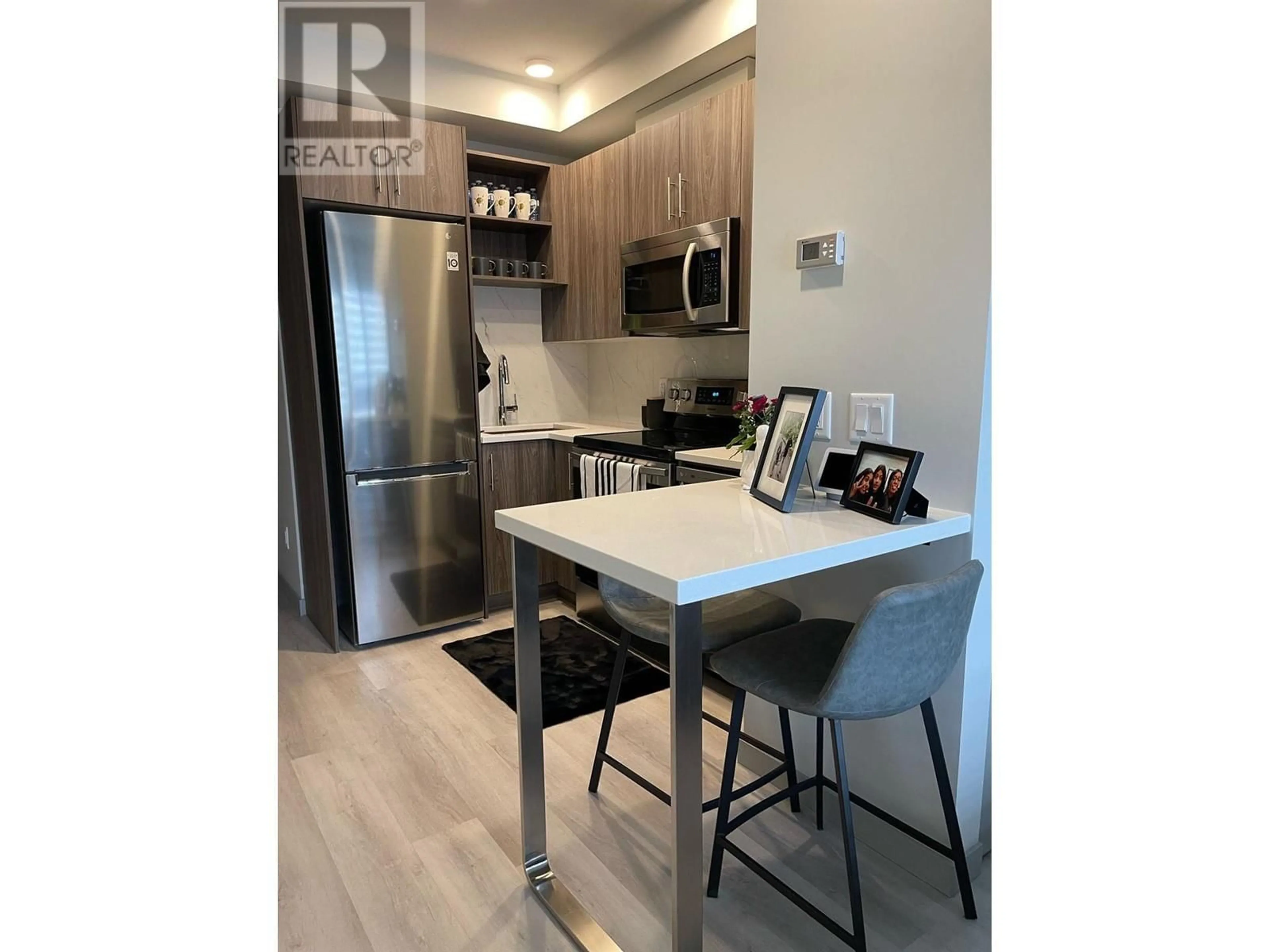 Open concept kitchen, wood/laminate floor for 215 - 345 DOUGALL ROAD NORTH, Kelowna British Columbia V1X3K8