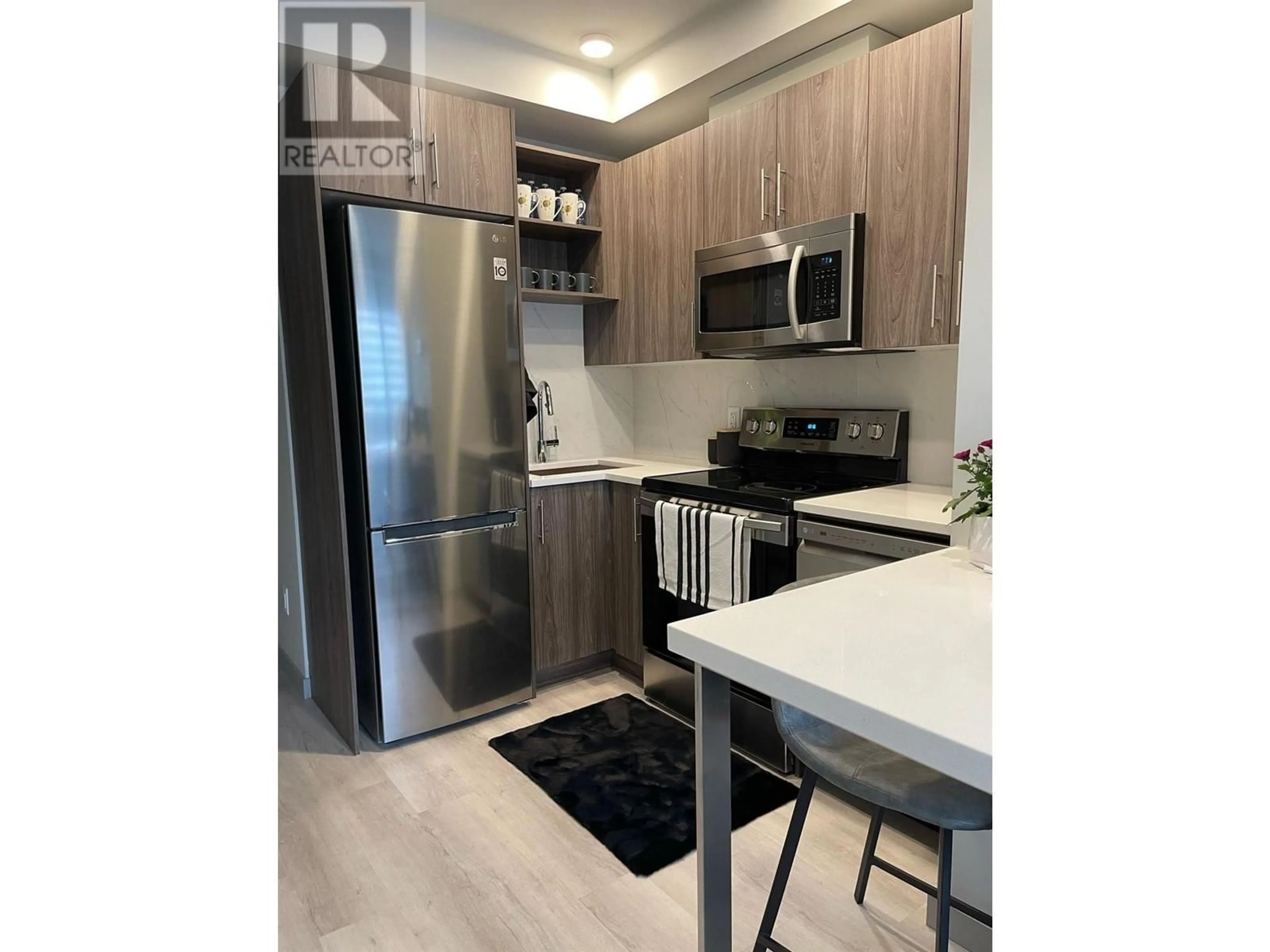 Open concept kitchen, wood/laminate floor for 215 - 345 DOUGALL ROAD NORTH, Kelowna British Columbia V1X3K8