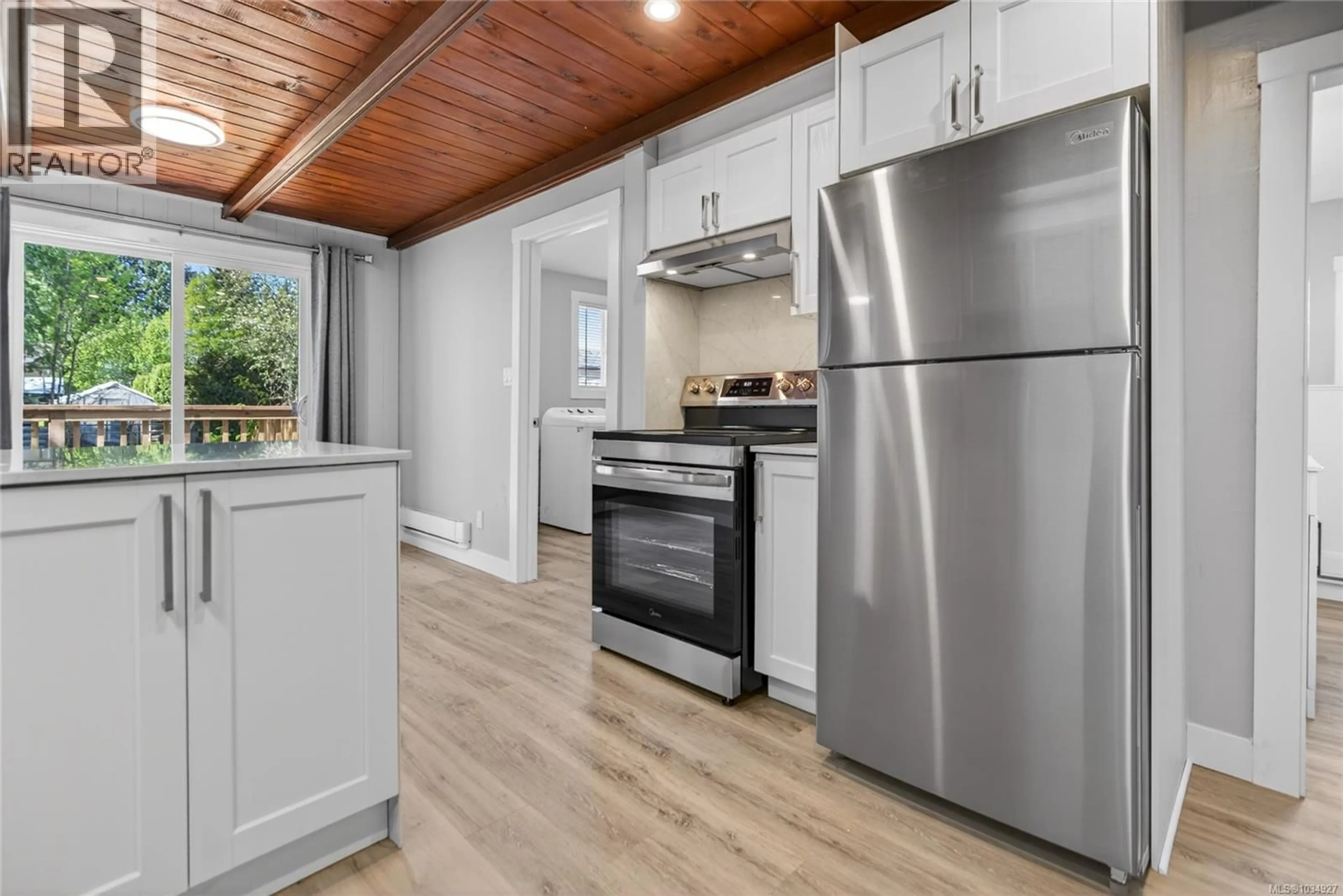 Open concept kitchen, wood/laminate floor for 1965 PIERCY AVENUE, Courtenay British Columbia V9N3G5
