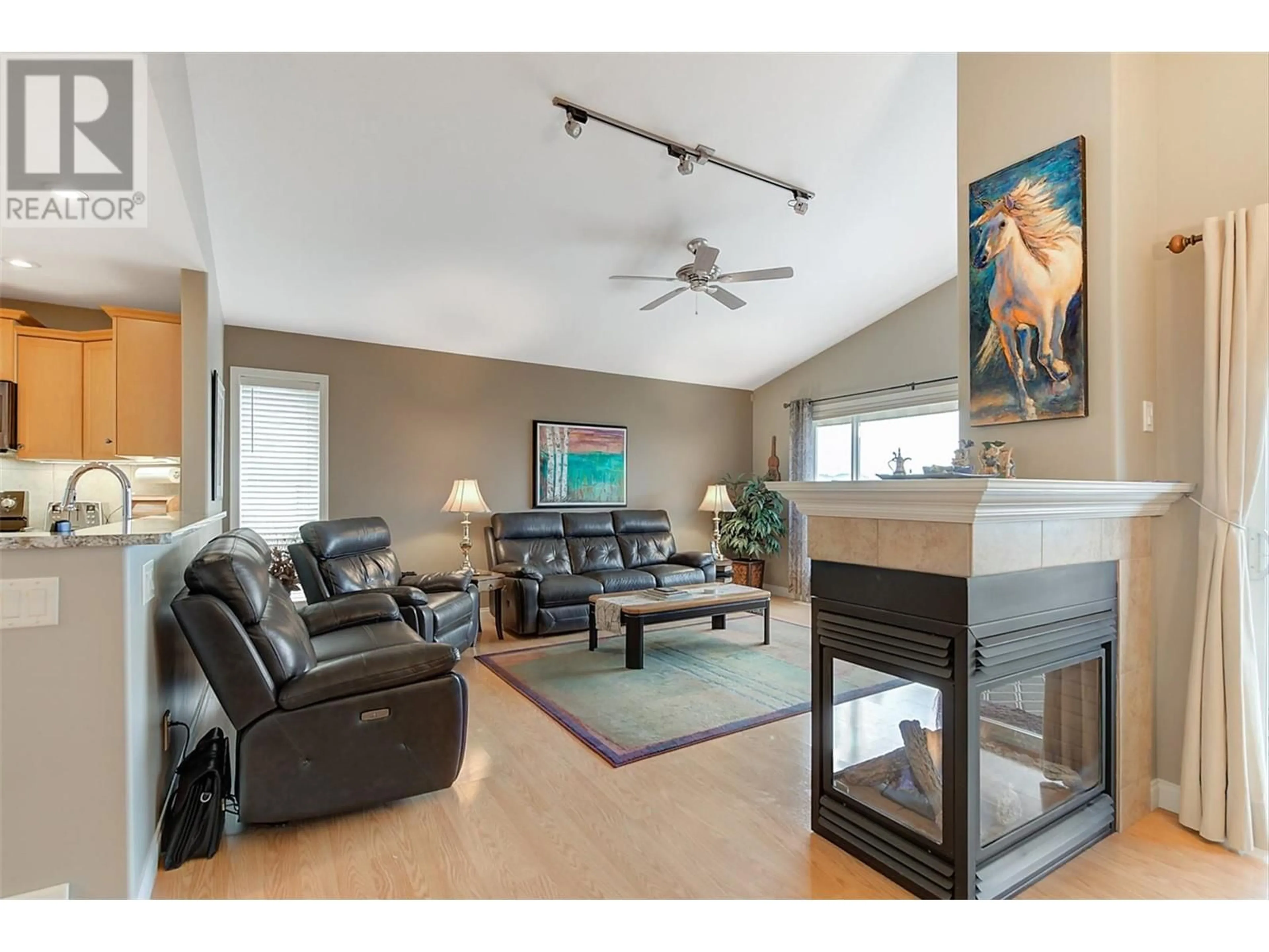Living room with furniture, wood/laminate floor for 5205 SANDHILLS DRIVE, Kelowna British Columbia V1X7Y7