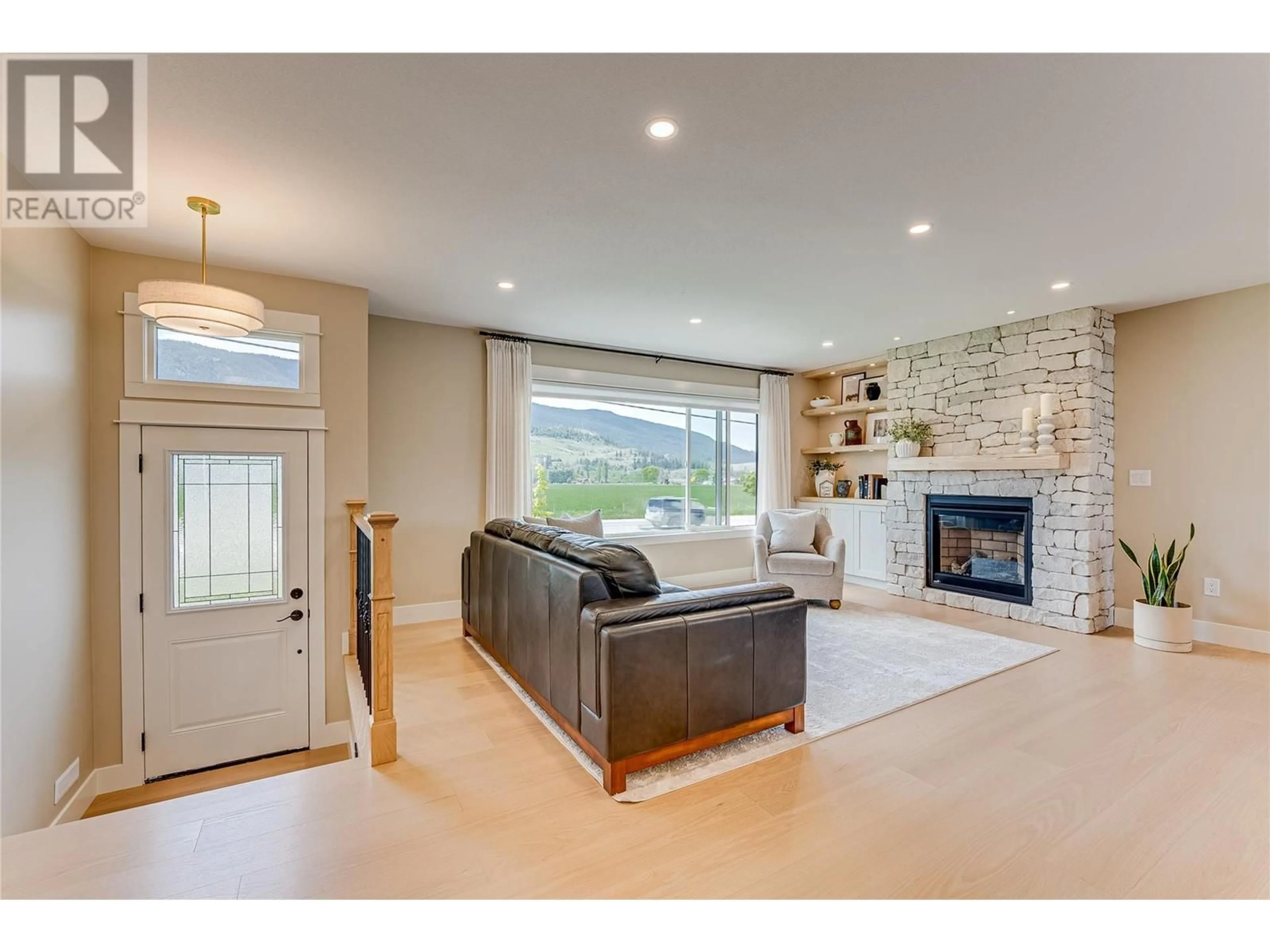 Living room with furniture, ceramic/tile floor for 8935 KALAMALKA ROAD, Coldstream British Columbia V1B3C2