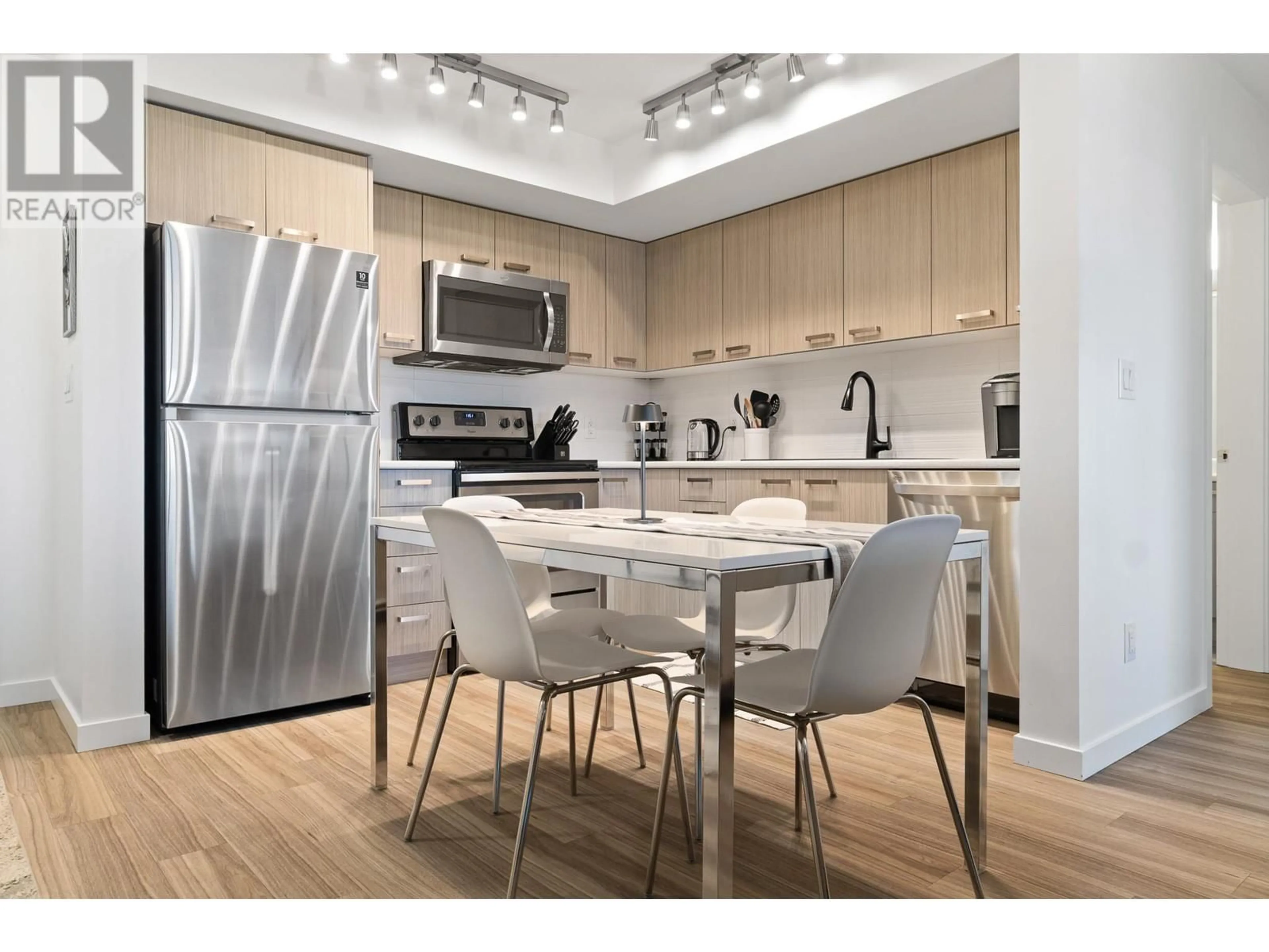 Open concept kitchen, wood/laminate floor for PH2 - 775 ACADEMY WAY, Kelowna British Columbia V1V0A5