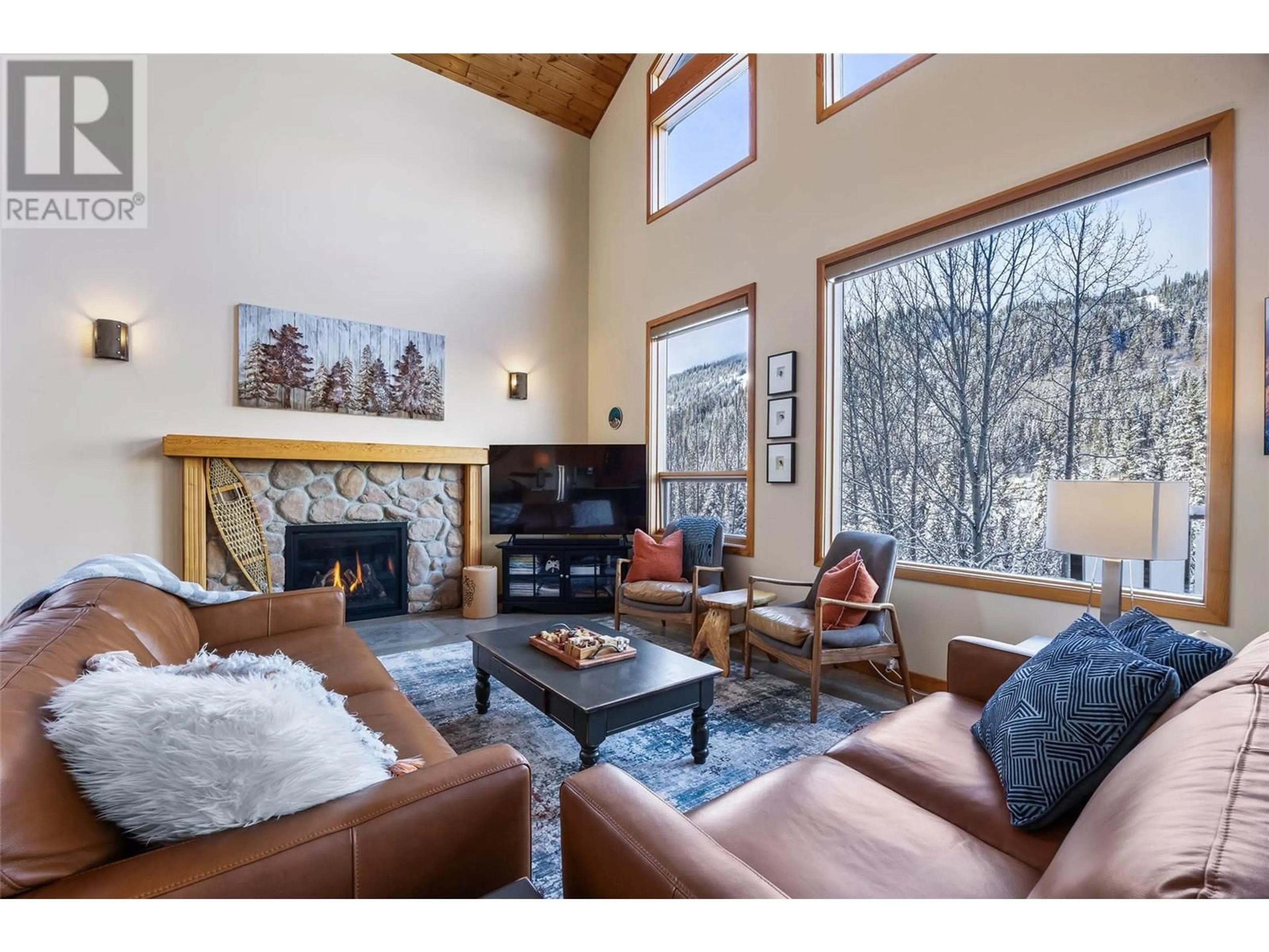 Living room with furniture, wood/laminate floor for 2416 FAIRWAYS DRIVE, Sun Peaks British Columbia V0E5N0