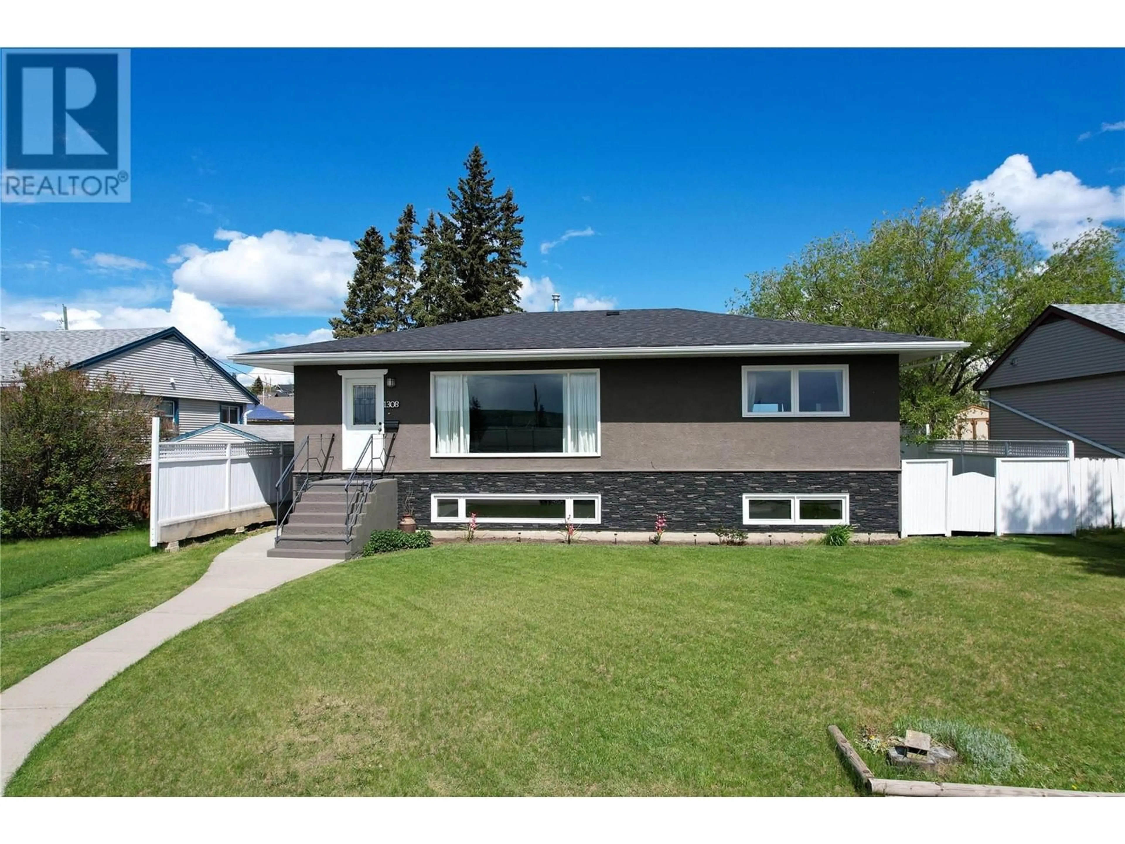Home with vinyl exterior material, street for 1308 94 AVENUE, Dawson Creek British Columbia V1G1G6