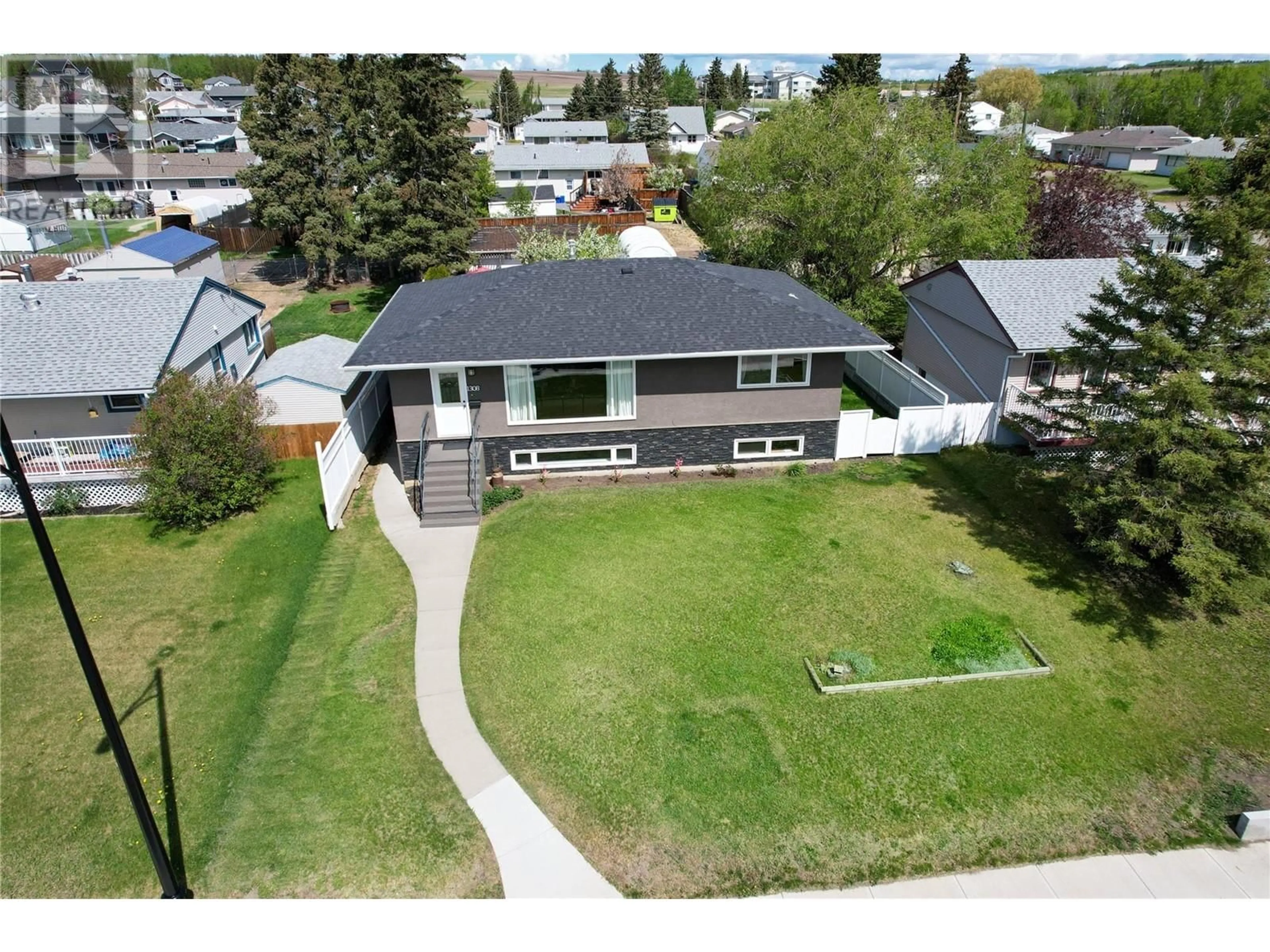 A pic from outside/outdoor area/front of a property/back of a property/a pic from drone, street for 1308 94 AVENUE, Dawson Creek British Columbia V1G1G6