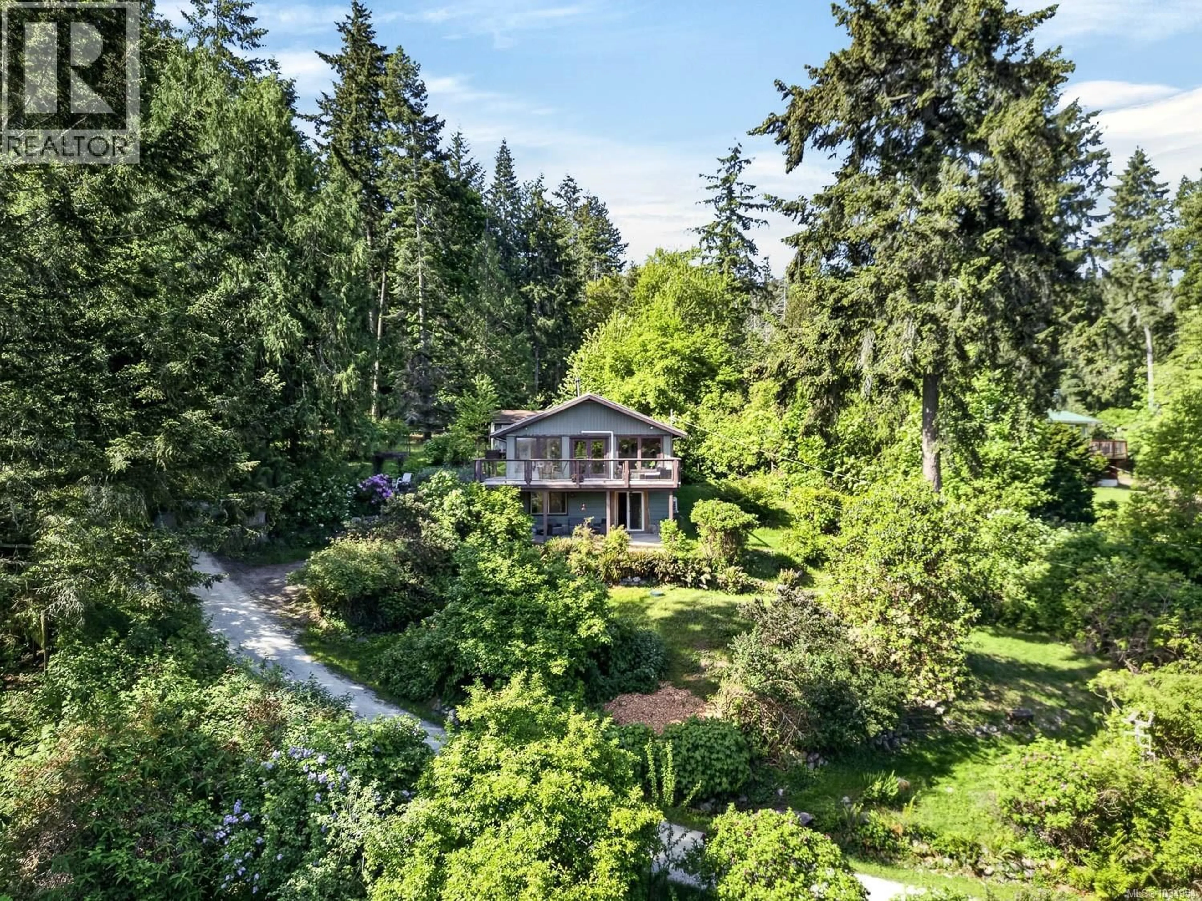 A pic from outside/outdoor area/front of a property/back of a property/a pic from drone, forest/trees view for 206 ROLAND ROAD, Salt Spring British Columbia V8K2B7