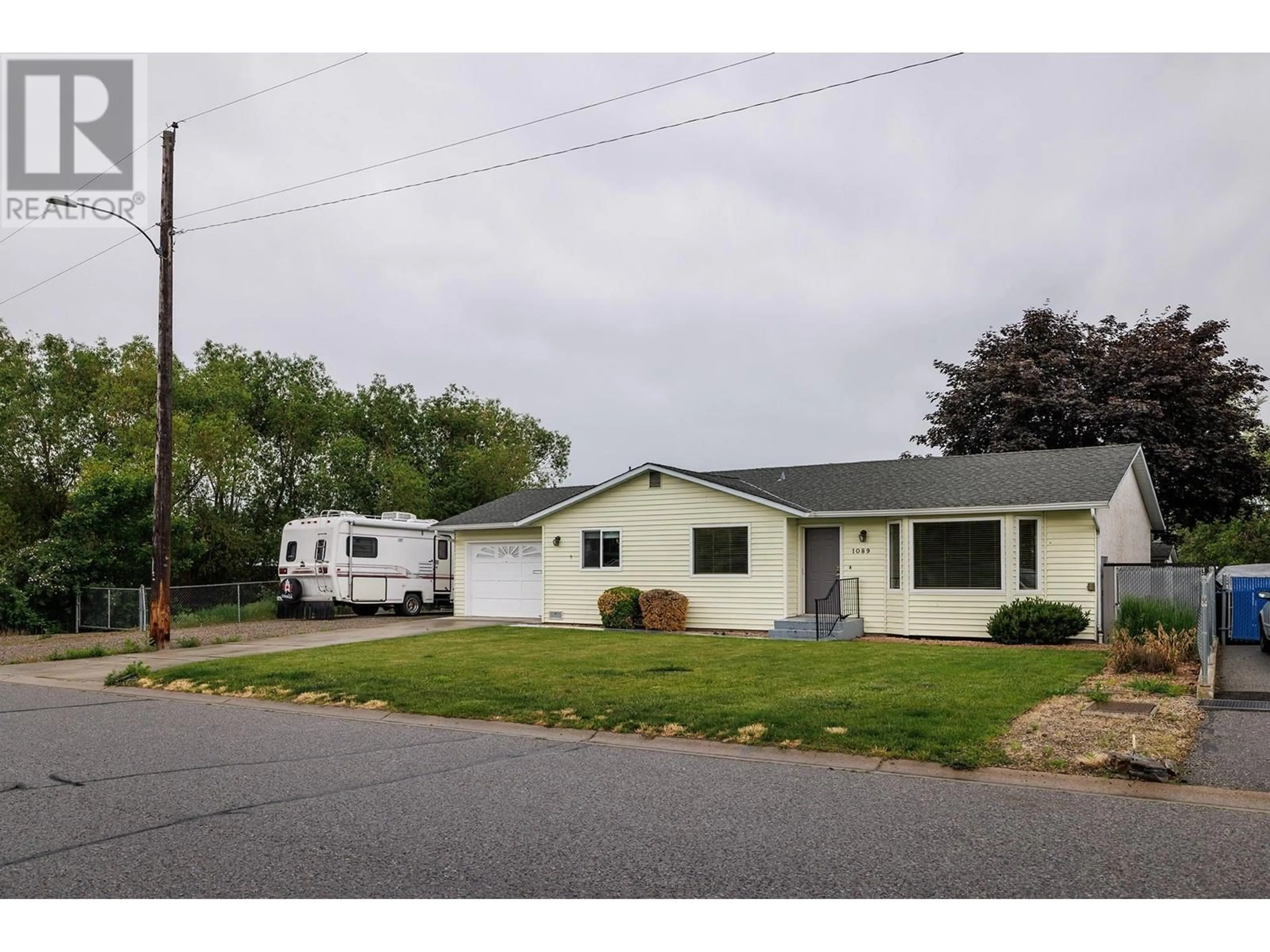 Home with vinyl exterior material, street for 1089 QUESNEL ROAD, Kelowna British Columbia V1Y3J4