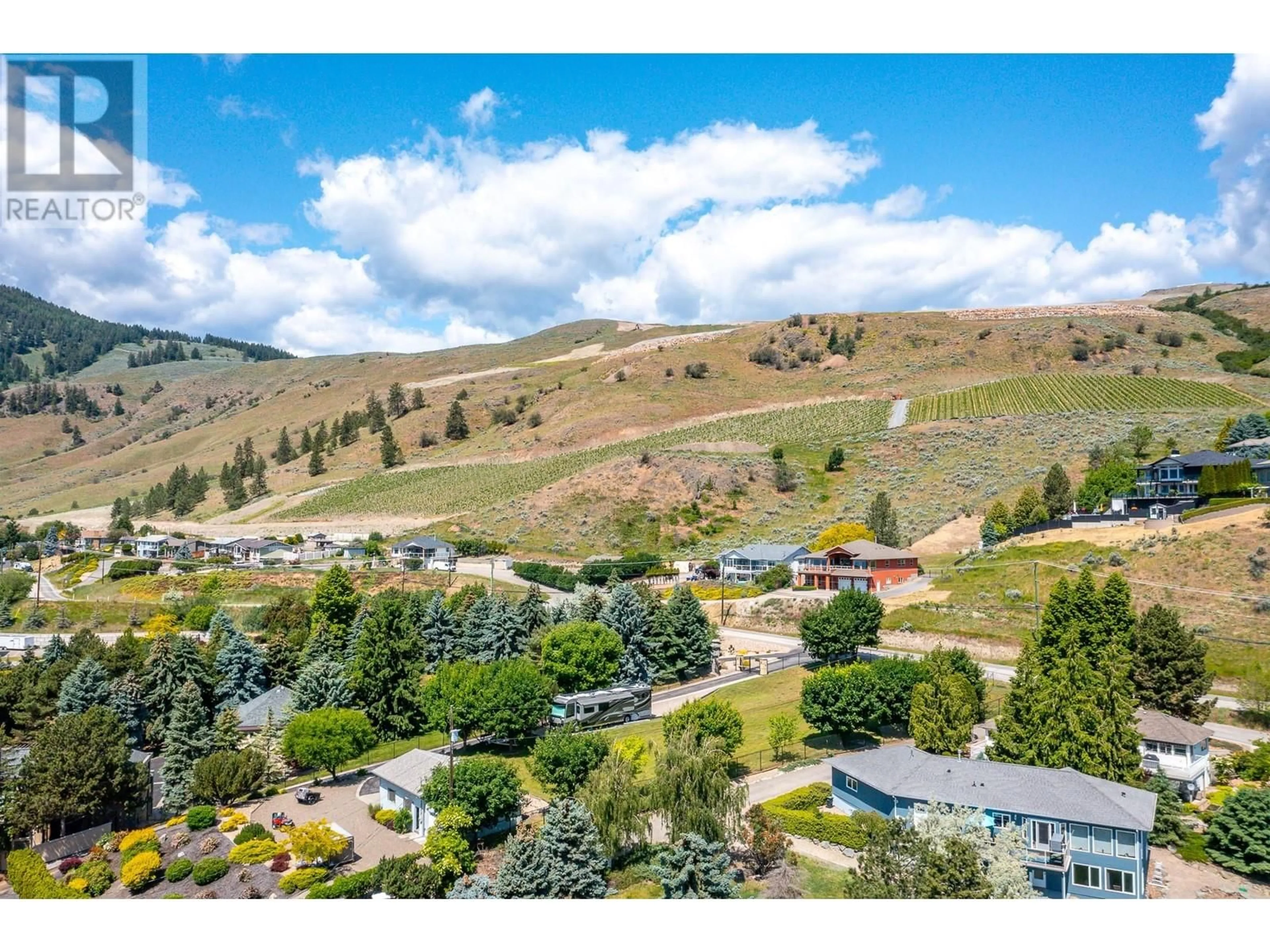 A pic from outside/outdoor area/front of a property/back of a property/a pic from drone, mountain view for 7551 TRONSON ROAD, Vernon British Columbia V1H1C4