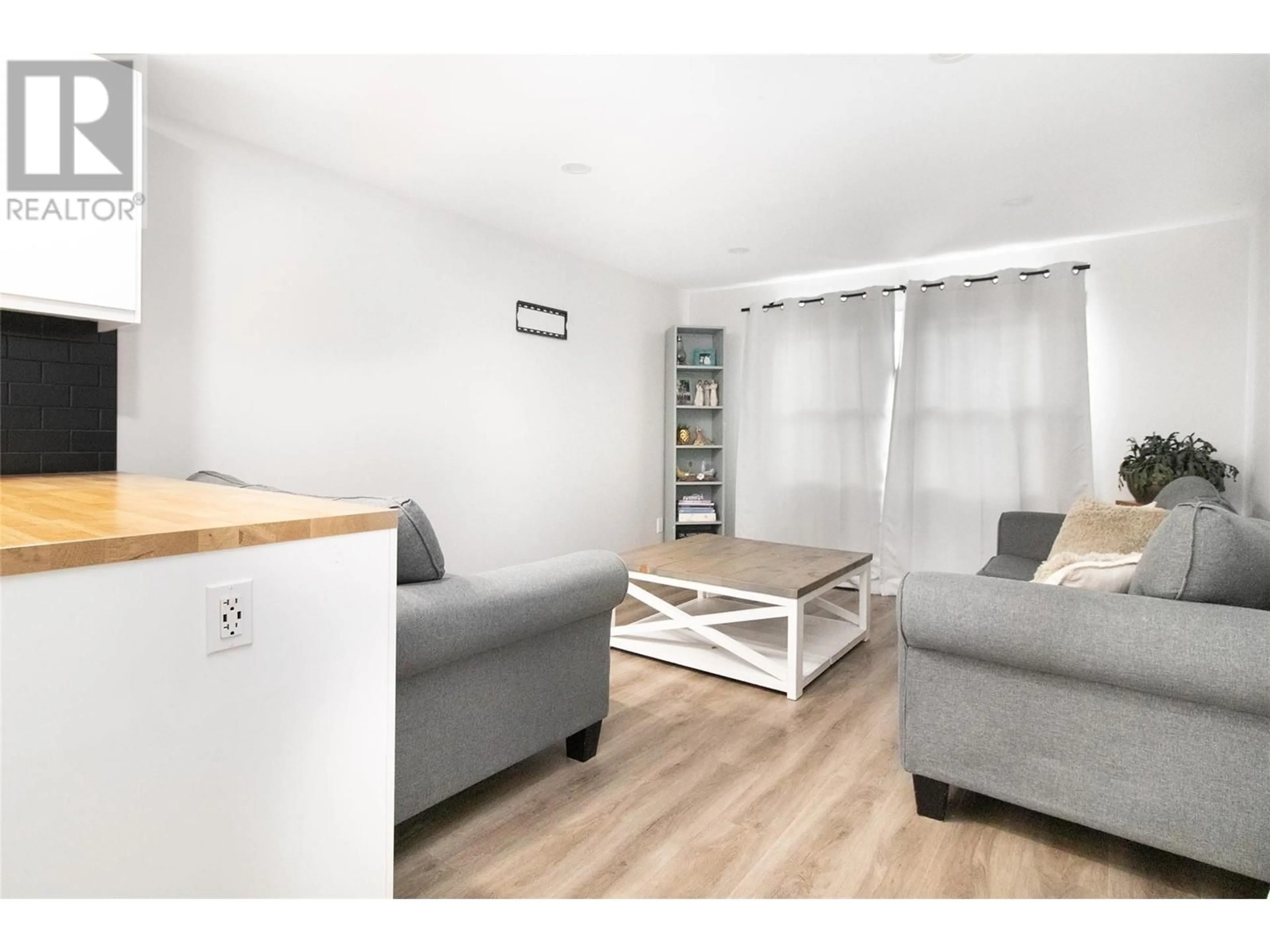 Living room with furniture, wood/laminate floor for 41 - 2065 BOUCHERIE ROAD, West Kelowna British Columbia V4T2A8