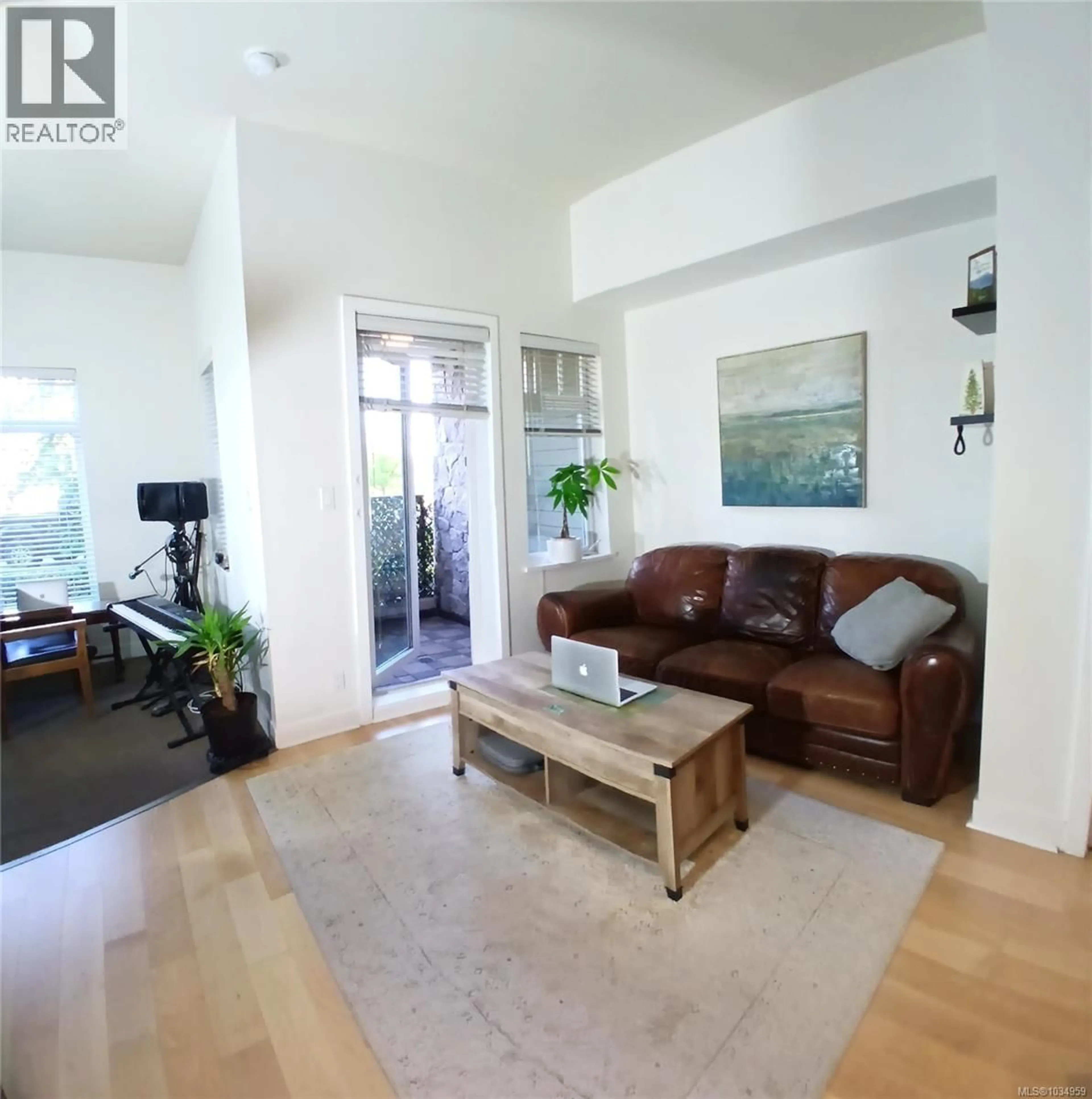 Living room with furniture, wood/laminate floor for 119 - 1395 BEAR MOUNTAIN PARKWAY, Langford British Columbia V9B0E1